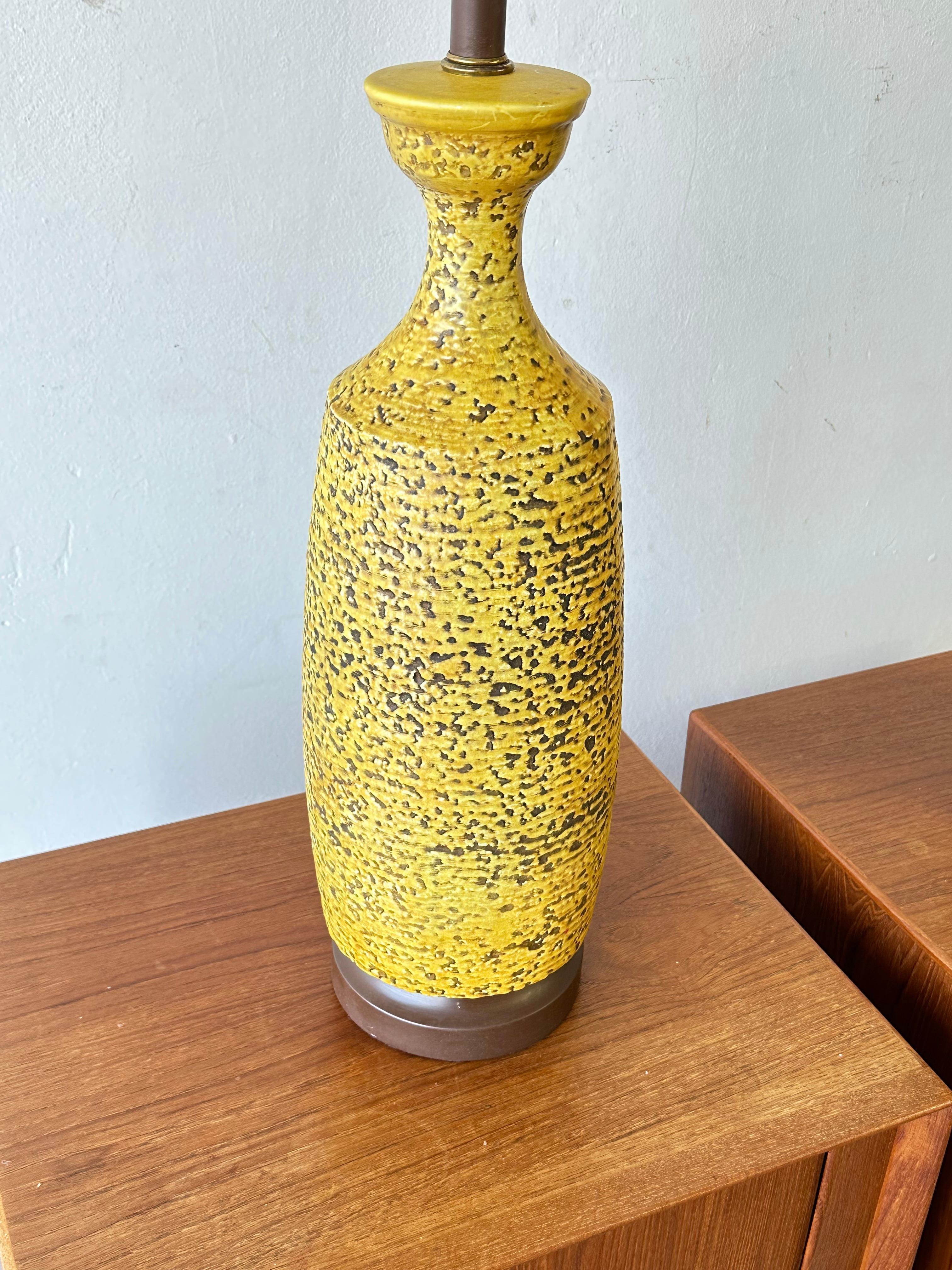 This is a set of LARGE Mid-Century Modern. ceramic table lamps One is green one yellow. These are ceramic lamps. Very unique set of lamps. These would look wonderful with a couple of drum shades. 

Shades are not included. Unless locally picked up.