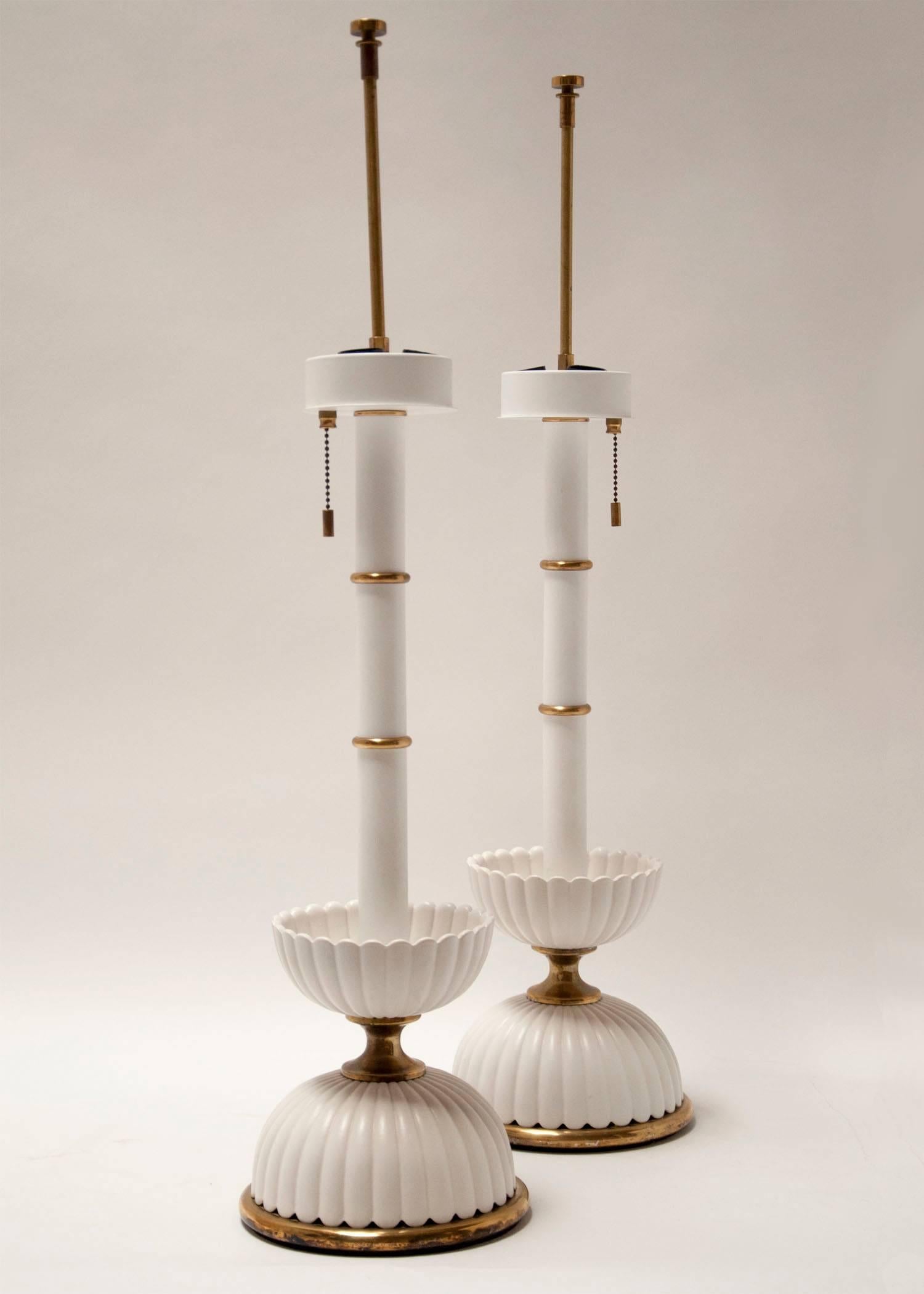 Pair of Lightolier lamps attributed to Gerald Thurston, circa 1950s. Matt white ceramic with brass accents. Beautiful condition with no cracks or chips to the ceramic parts. Mid-Century Modern and Hollywood Regency style.
23.5