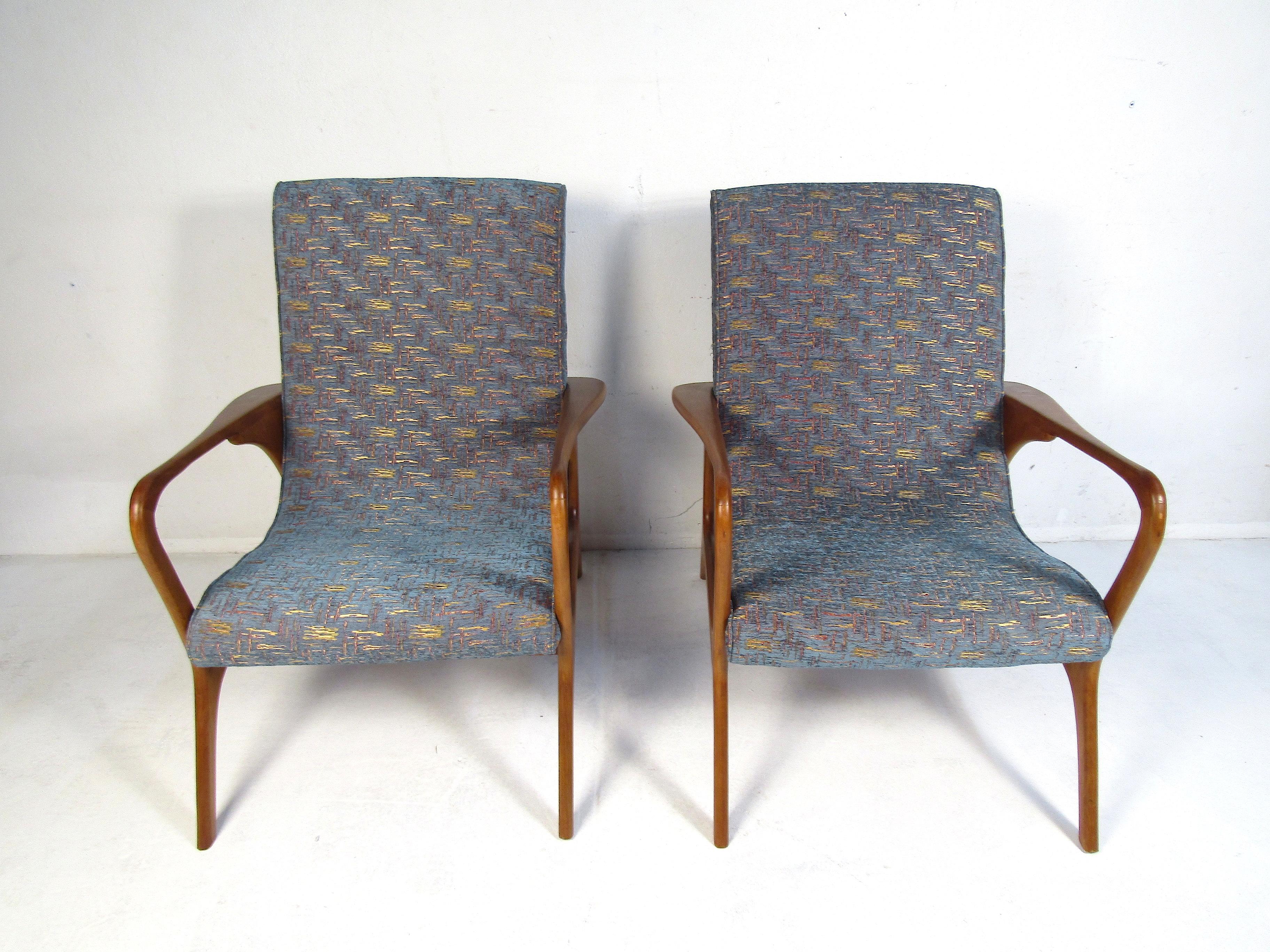Stylish pair of midcentury lounge chairs. Sculpted frame with an interesting profile. Nice addition to any modern interior. Please confirm item location with dealer (NJ or NY).