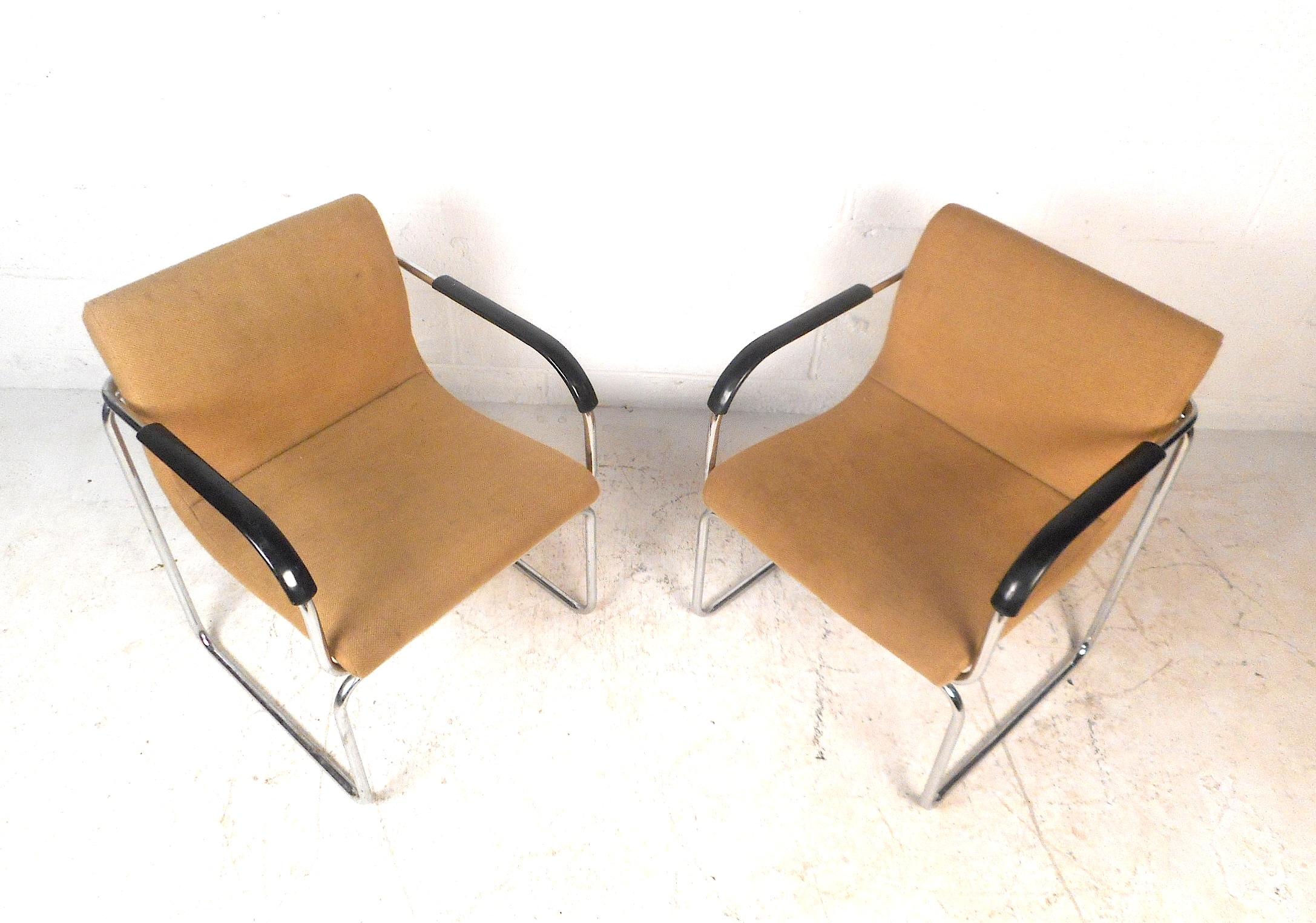 This impressive pair of vintage modern lounge chairs features a sturdy chrome frame and a form-fitting backrest. The chairs are upholstered with a comfortable sand-colored fabric. These Art Deco style lounge chairs will provide a seating arrangement