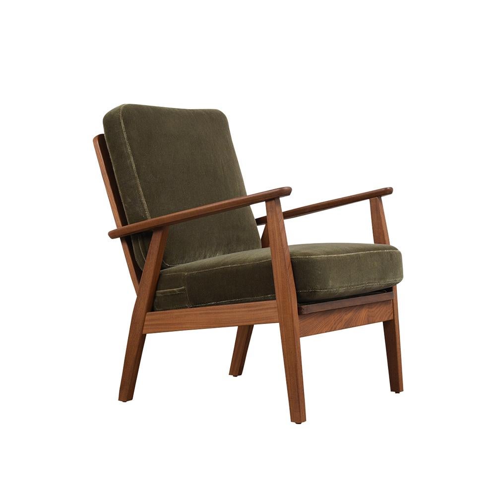 This pair of 1960s Mid-Century Modern style lounge chairs feature a teak wood frame with its original walnut finish. The cushions are newly upholstery and a dark green color mohair fabric with topstitch details and new foam inserts. This pair of