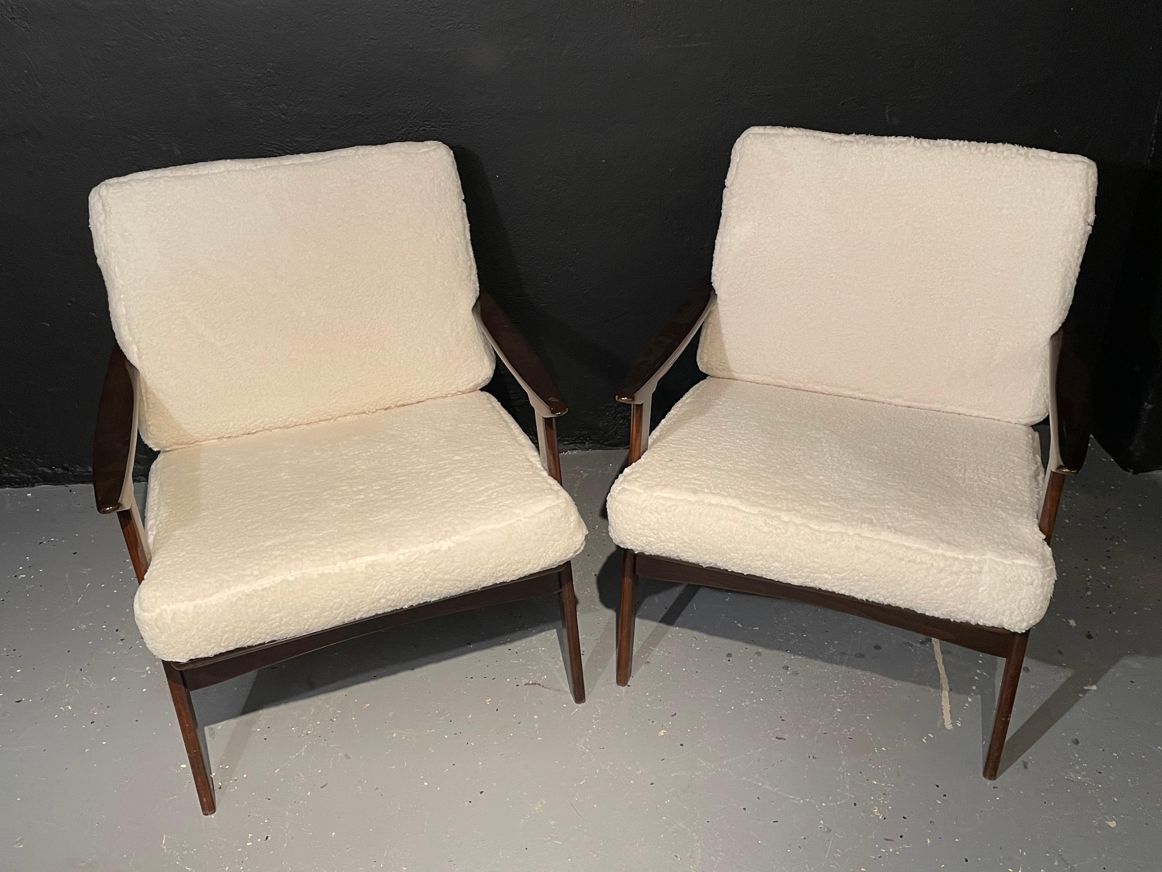 Pair of Mid-Century Modern lounge chairs in the style of Ib Kofod-Larsen having a new Plush Sherpa fabric. This fine pair of custom quality lounge or armchairs in the stylish fashion of Larsen each having a new Sherpa upholstery pair of cushions are