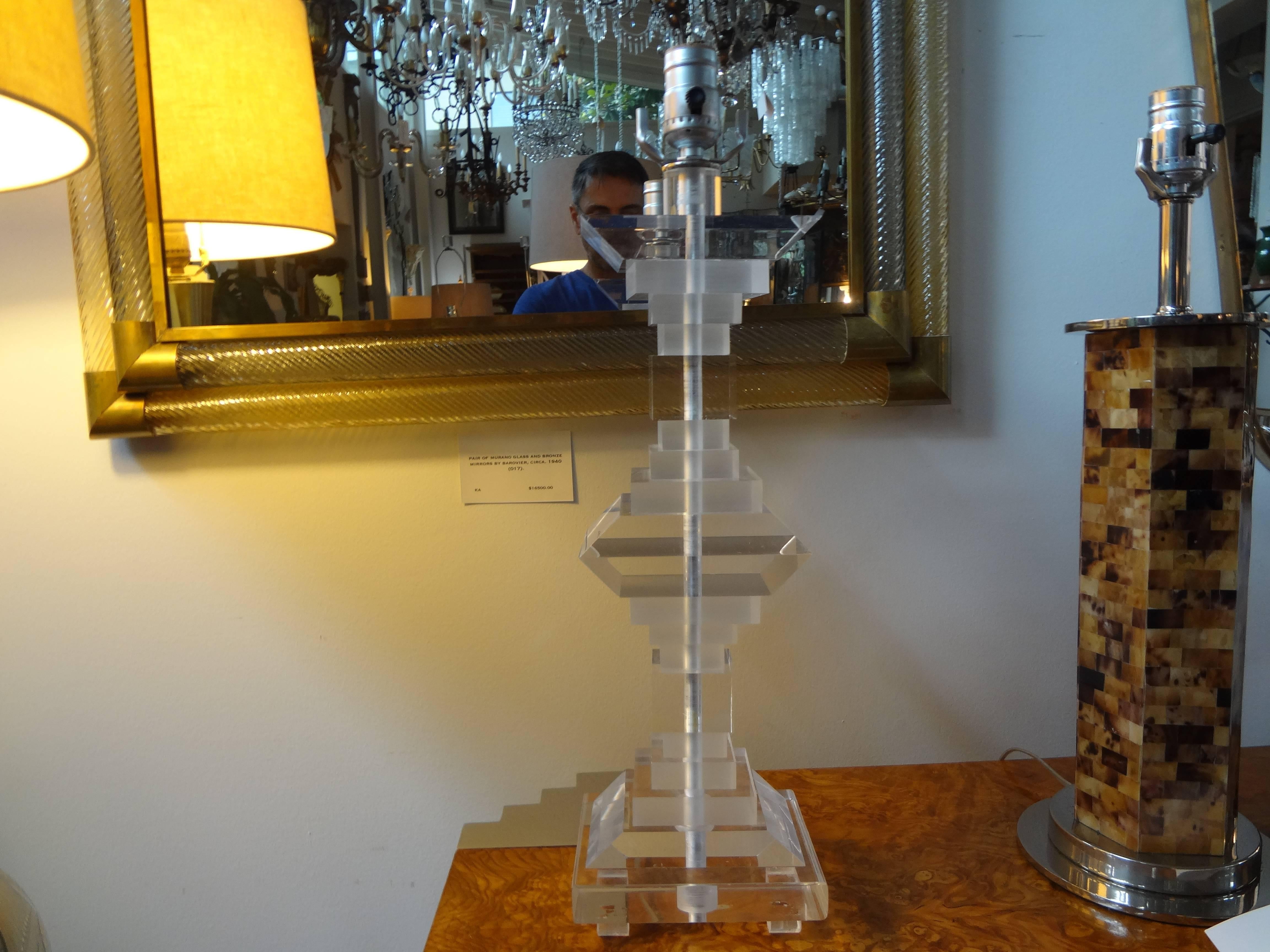 Pair of Mid-Century Modern lucite table lamps.
Stunning pair of Art Deco style stacked lucite or acrylic lamps in the style of Les Prismatiques or Karl Springer. These Hollywood Regency geometric form lamps have been newly wired and date to the