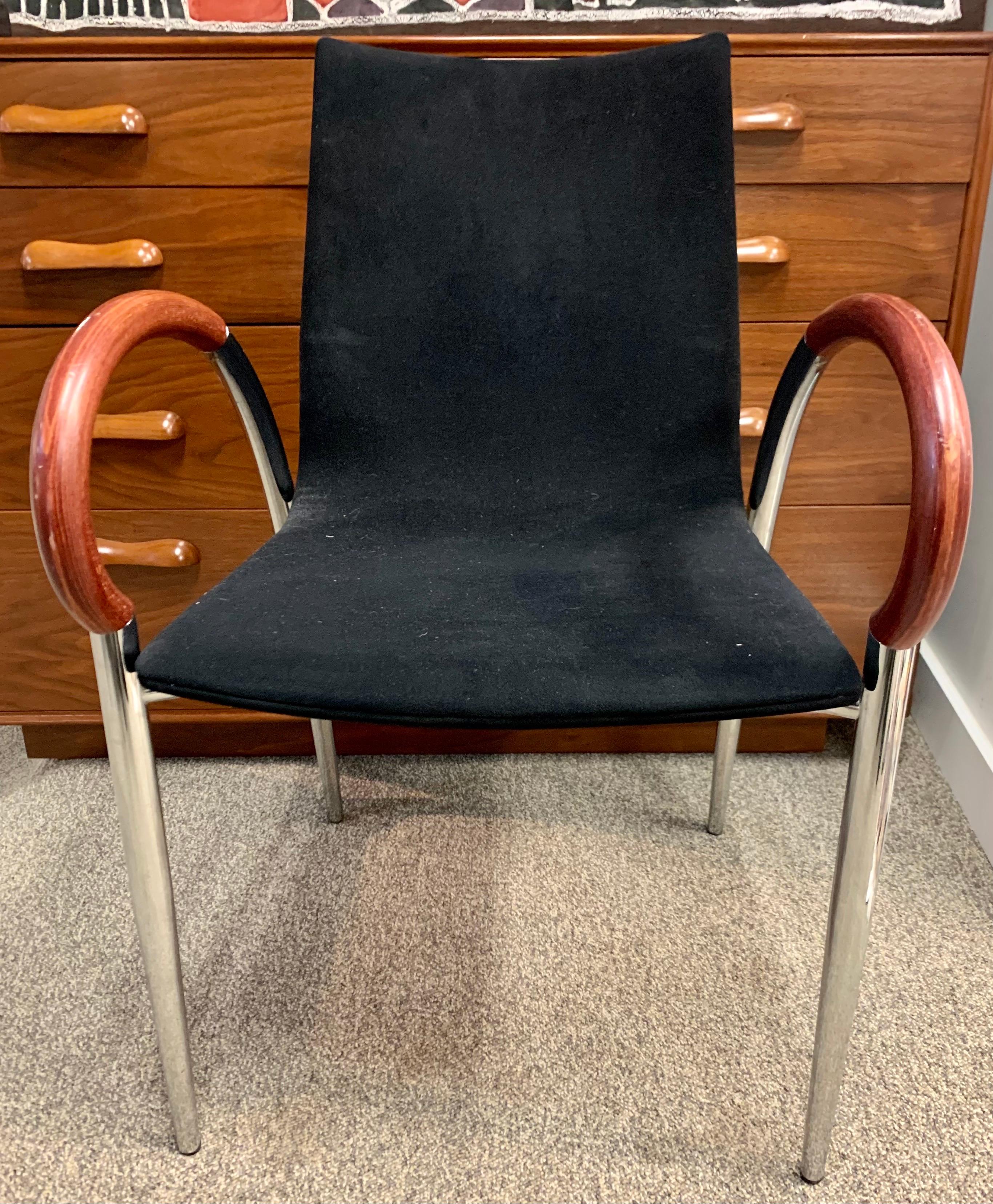 Elegant and unusual pair of Mid-Century Modern dining chairs where the arms are made of what looks like rosewood. The color of seat is black. Made in Italy. Now, more than ever, home is where the heart is.
The fabric looks and feels like suede but
