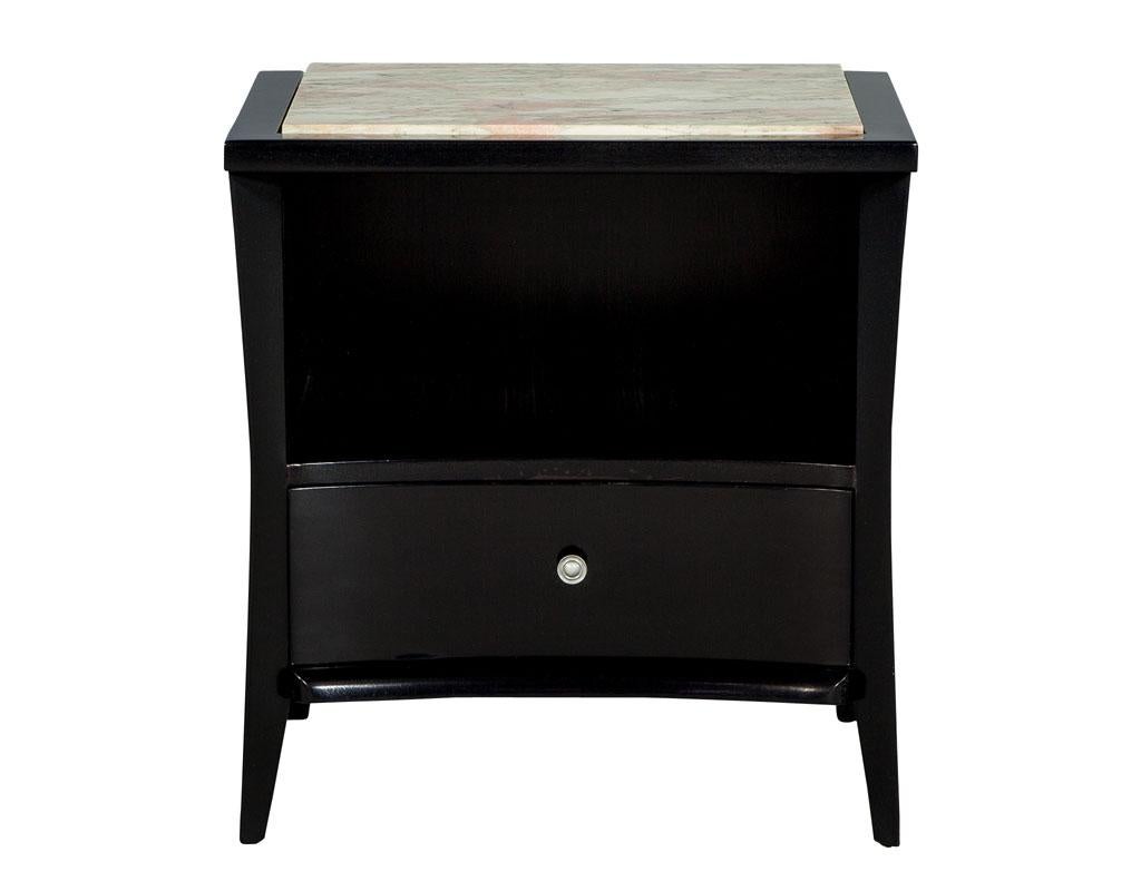 This pair of Mid-Century Modern marble-top nightstands end tables date back to the Mid-Century Modern era. This table features four slim, curved legs, one drawer and a shelf for storage. It also has the original marble top insert for added