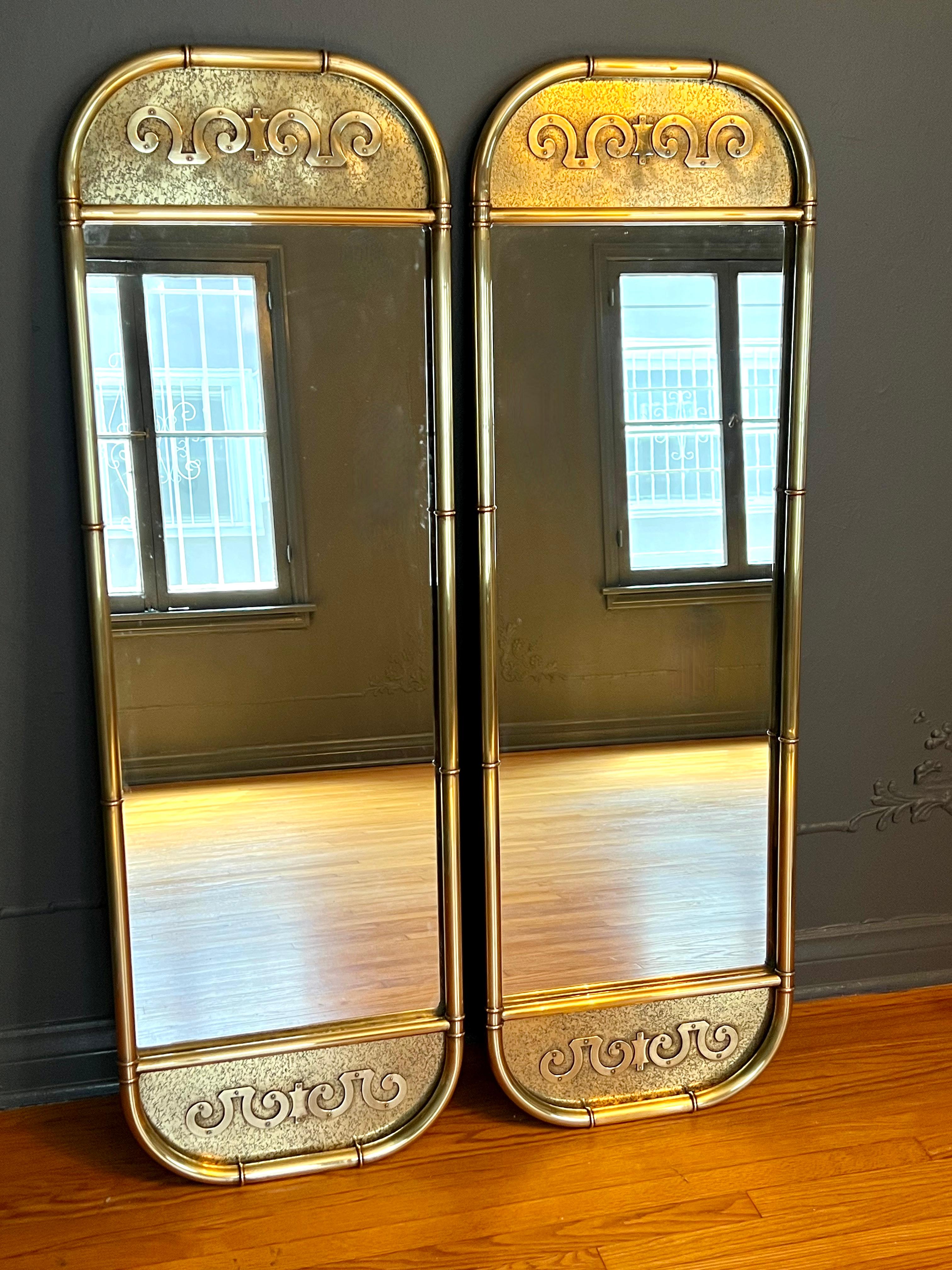 A pair of mid century brass Mastercraft wall mirrors. The pair are very tall at 56.5