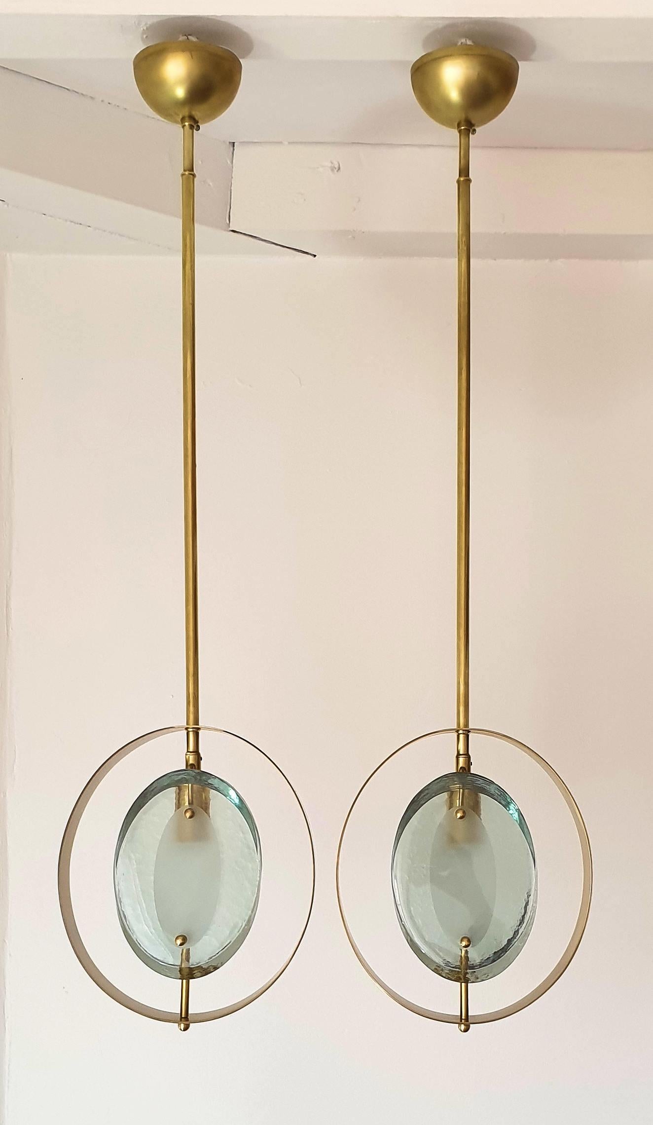 Pair of Mid-Century Modern, polished brass and green glass pendants, in the style of model 1933, by Max Ingrand for Fontana Arte, Italy, 1961.
They have 1 light each and have been rewired for the US.
The height of the stem can be changed.
Size: