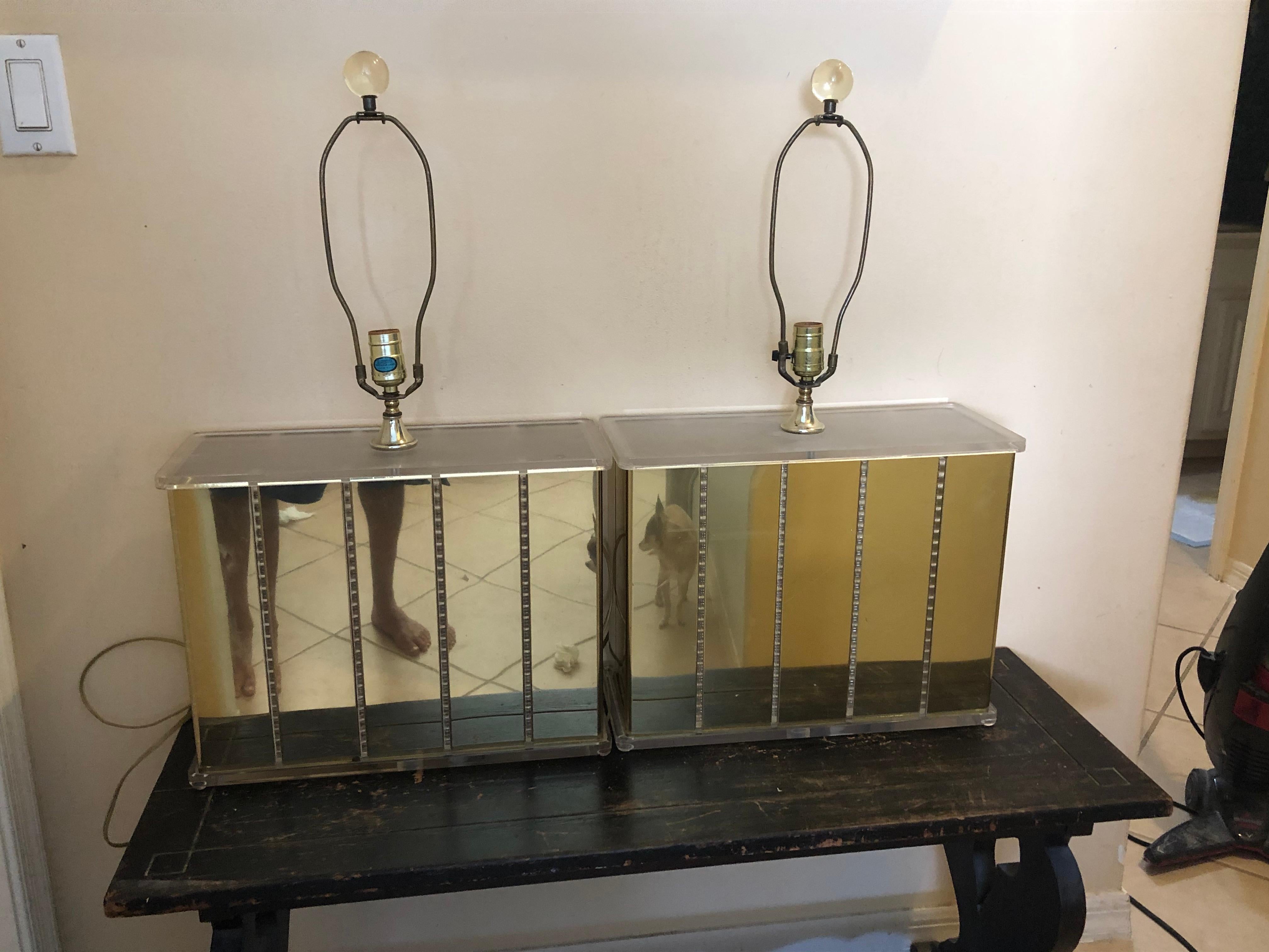 Fabulous pair of Lucite and mirrored brass or gold plate. Lamps by Optique. These are the largest and widest I have seen of this rare style. Probably made in the 1970s.
