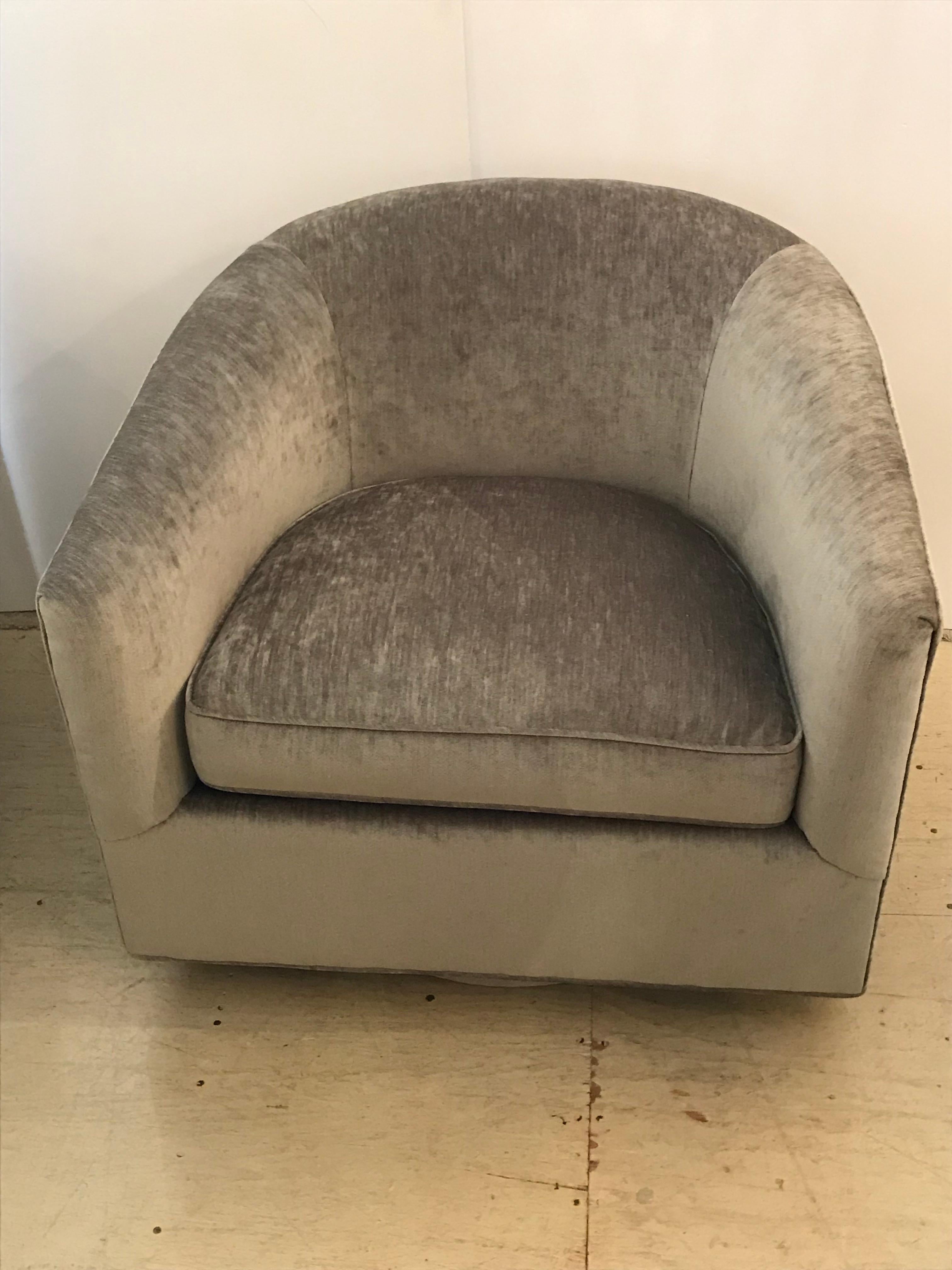 Cool pair of Milo Baughman style 360 degree swivel chairs in newly upholstered cut velvet fabric in a medium shade of grey. Fabric has a slight stripe pattern to it. Measure: Seat height is 18. Very comfortable as well as chic.
  