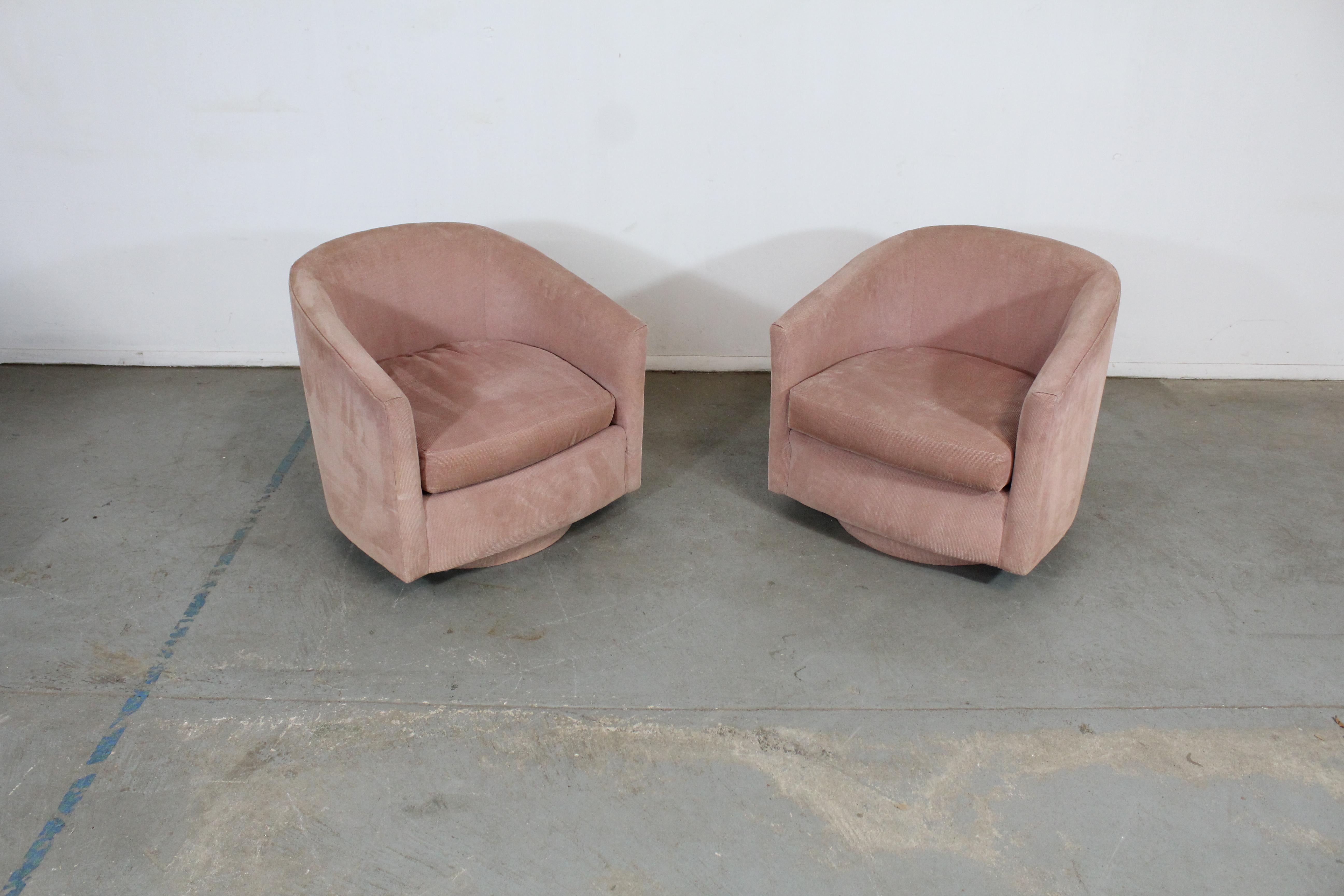 Pair of Mid-Century Modern Milo Baughman style swivel club chairs 

 Offered is a pair of Mid-Century Modern Milo Baughman style swivel rocker chairs. These chairs rock and tilt. They are on a platform base. This unique pair could stand to have