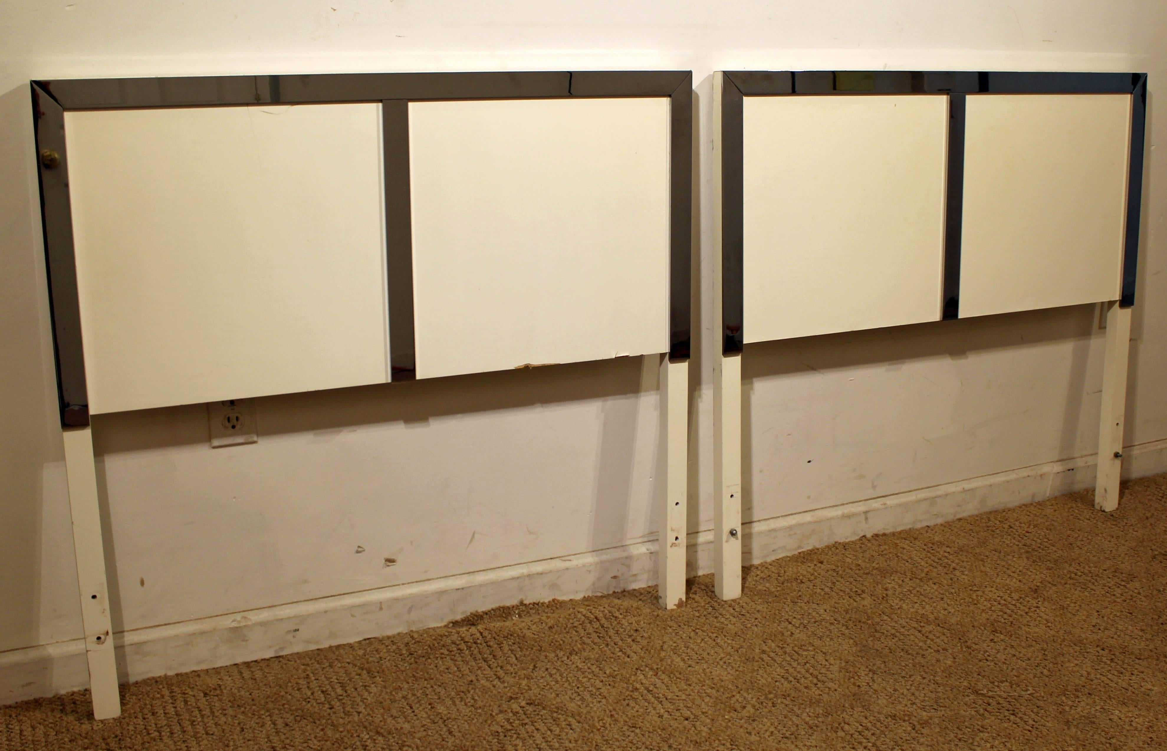 What a find. Offered is a pair of vintage Mid-Century Modern twin size headboards featuring chrome trim. This set does not include rails or a foot boards. They are not signed.

Dimensions:
38.5