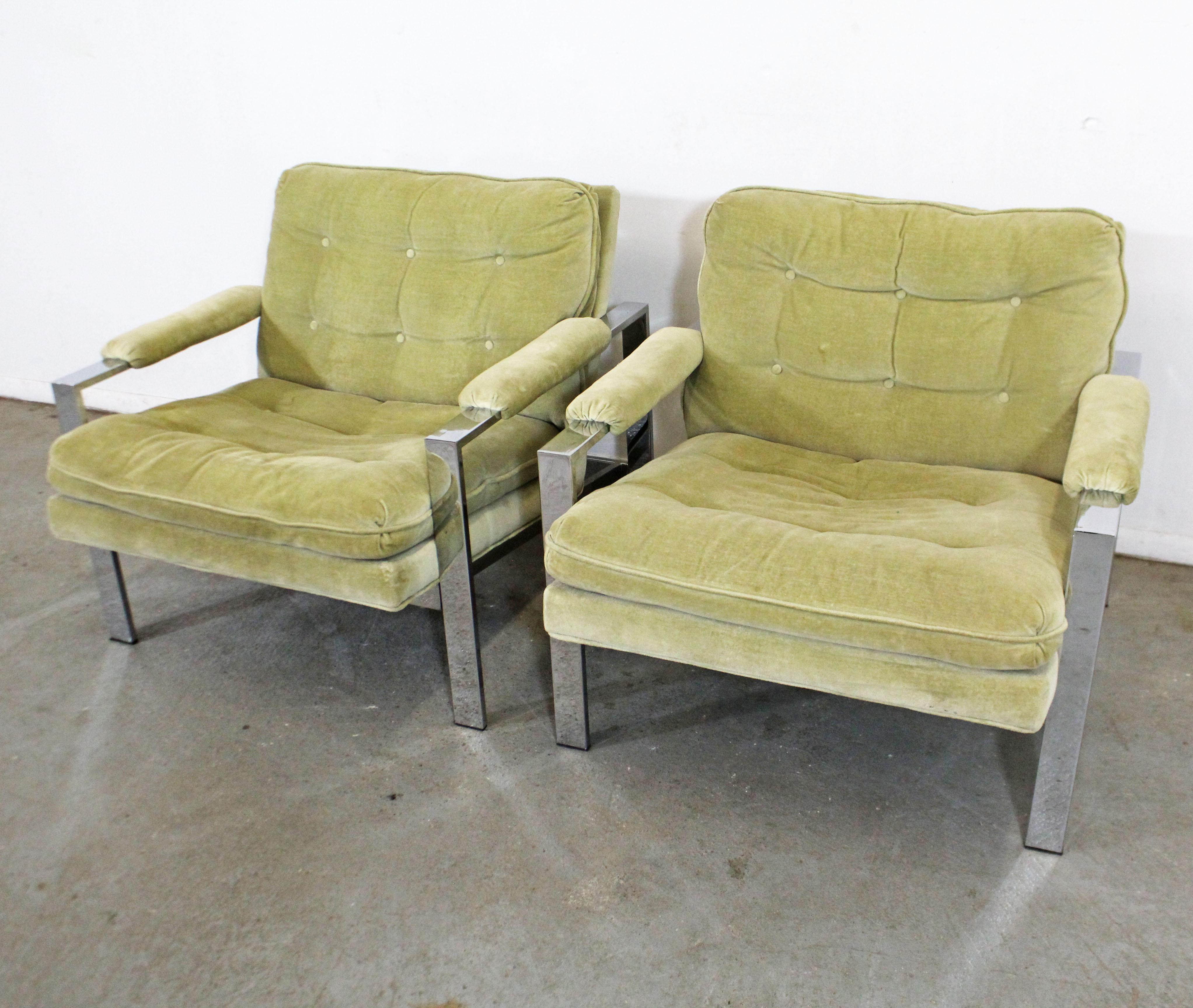 What a find. Offered is a pair of vintage Mid-Century Modern lounge chairs, designed by Milo Baughman for Thayer Coggin. They each have a chrome base and upholstered seats and arms. They are in decent condition, showing age wear (sun fade/stains on