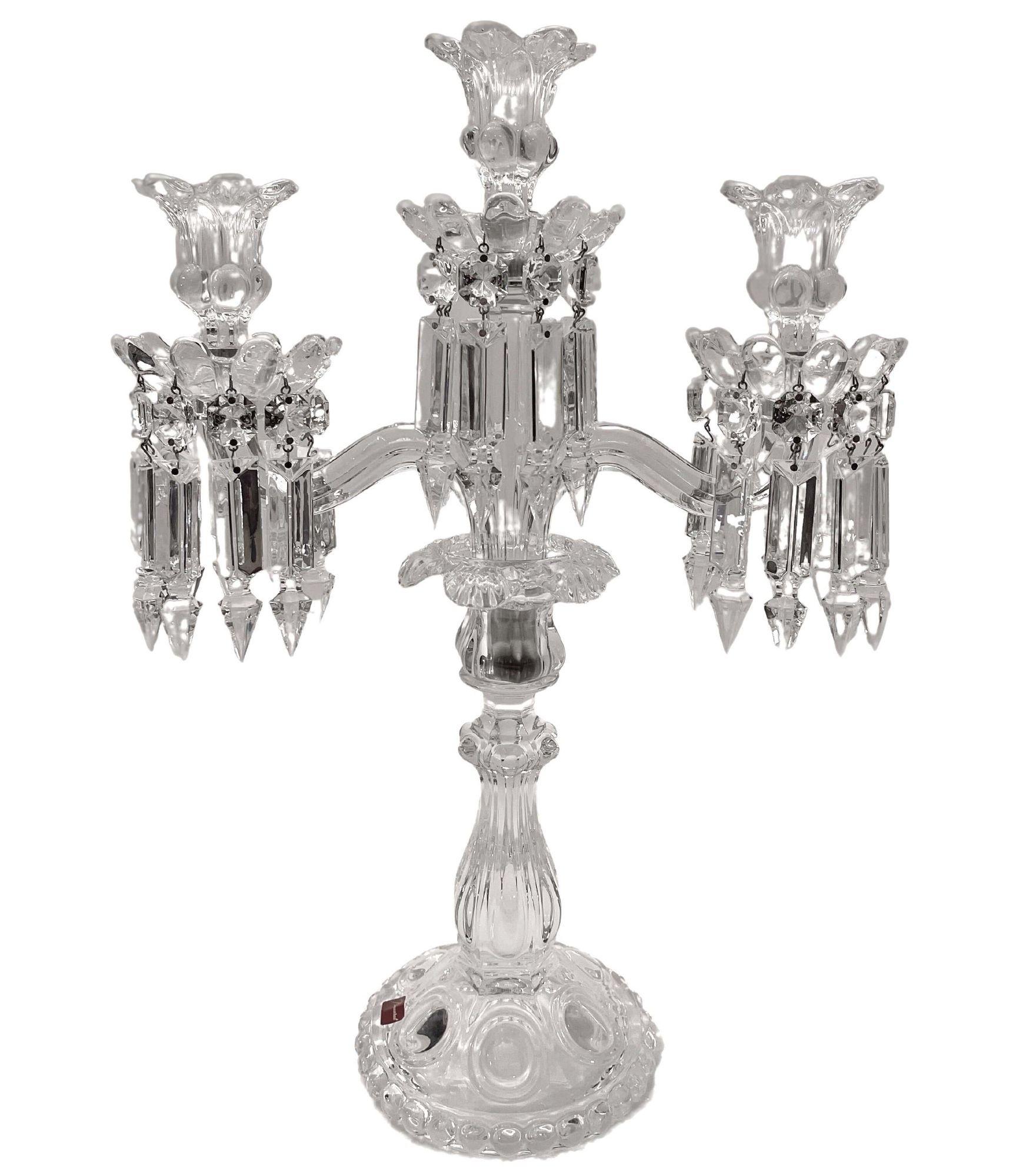 Pair of Mid-Century Modern neoclassical glass Obelisk candelabras by Baccarat. Handblown, etched and beveled translucent crystal. They also feature circular scalloped bases with demilune detailing as well as raised domed forms that incircle the