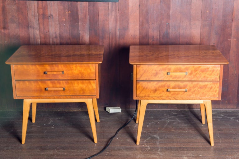 Pair of Renzo Rutili designed side tables for Johnson Furniture Company. Solid wood. Cabinets have two drawers with solid brass trimmed wood pulls , sitting on splayed legs. Labeled.