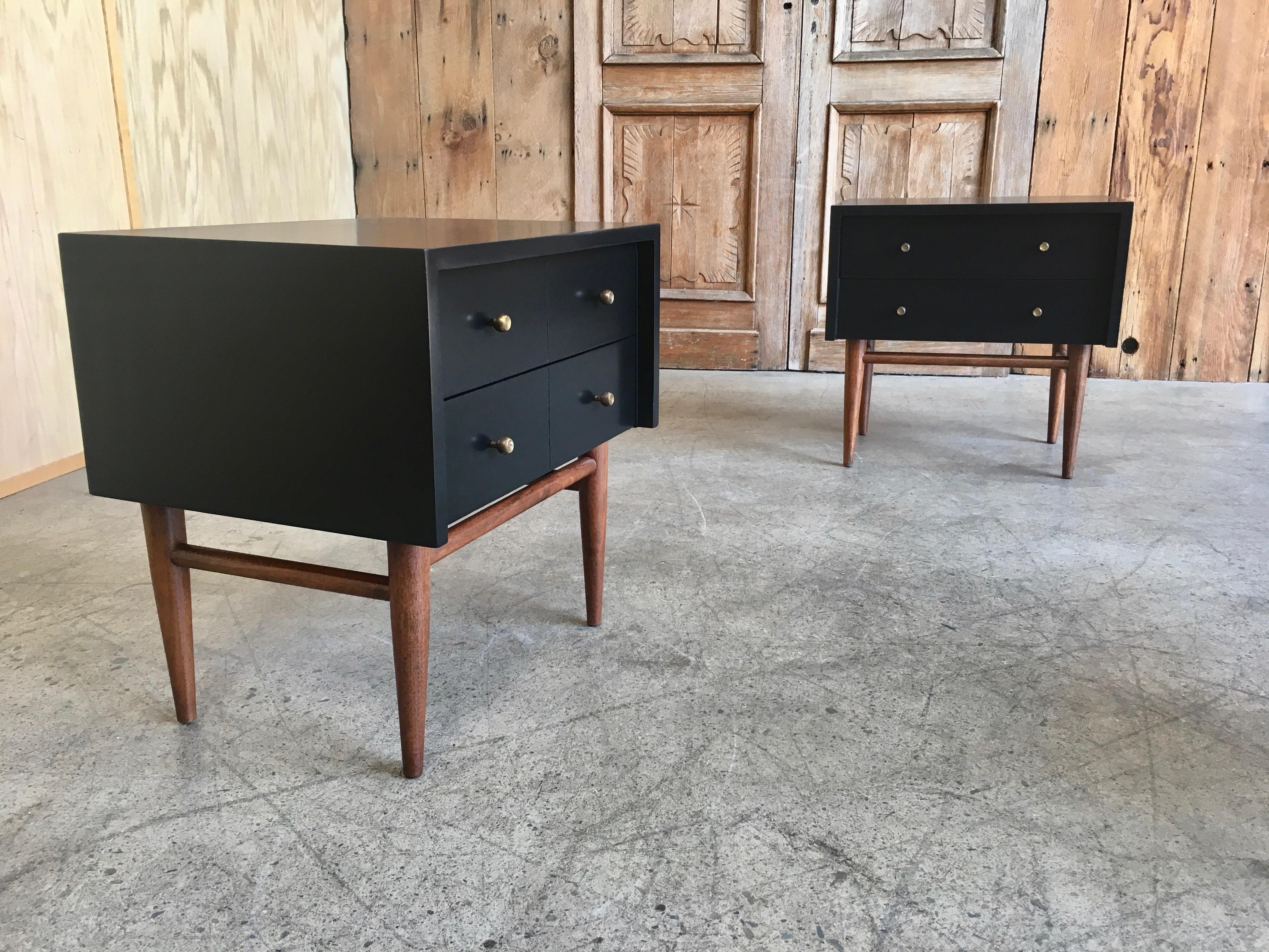 Early pair of American of Martinsville nightstands. Designed by Merton L. Gershun with ebonized top with walnut legs.