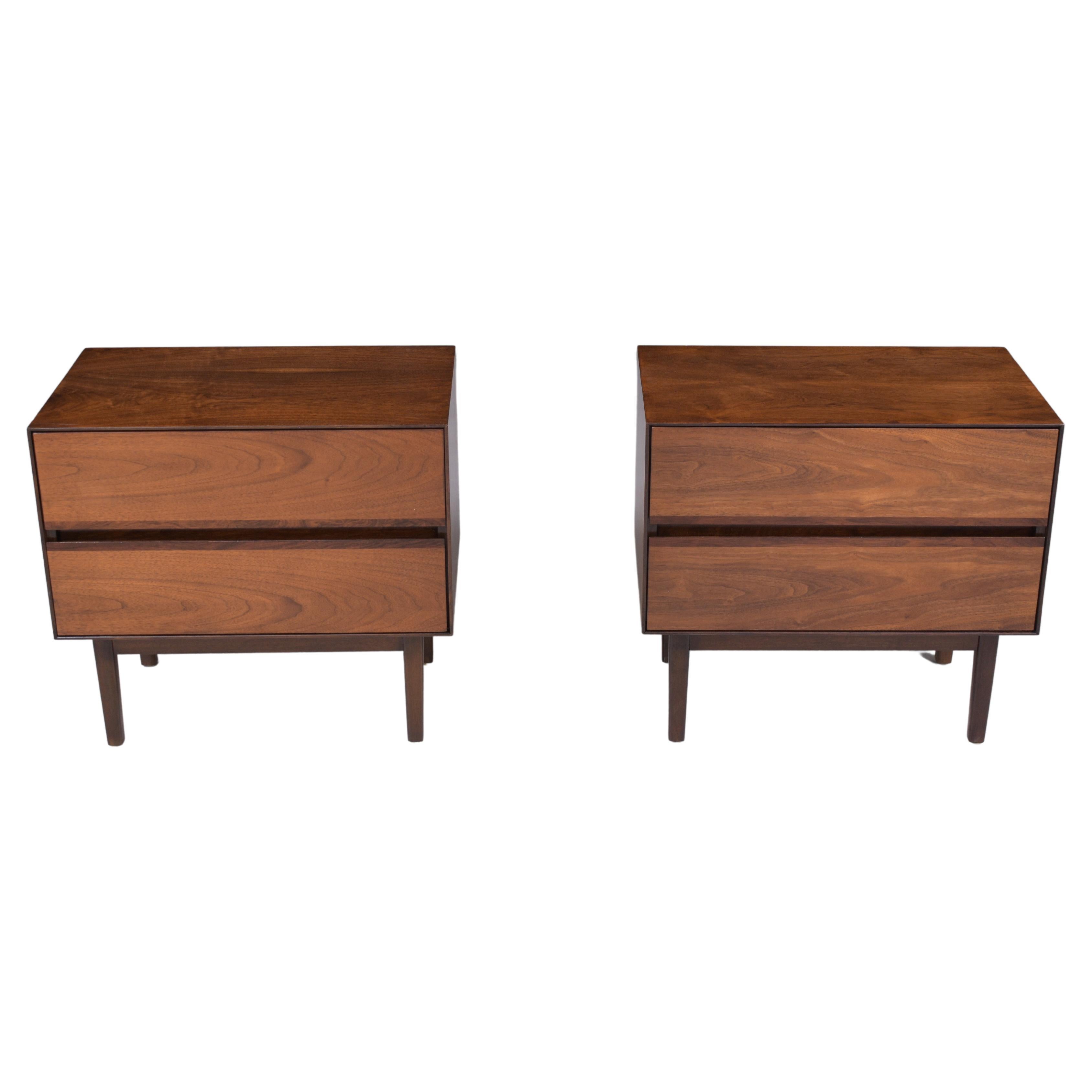 An extraordinary pair of 1960s nightstands are hand-crafted out of walnut and are in a great condition completely restored and refinished by our professional craftsmen team. These pair of mid-century modern bedside tables are eye-catching and