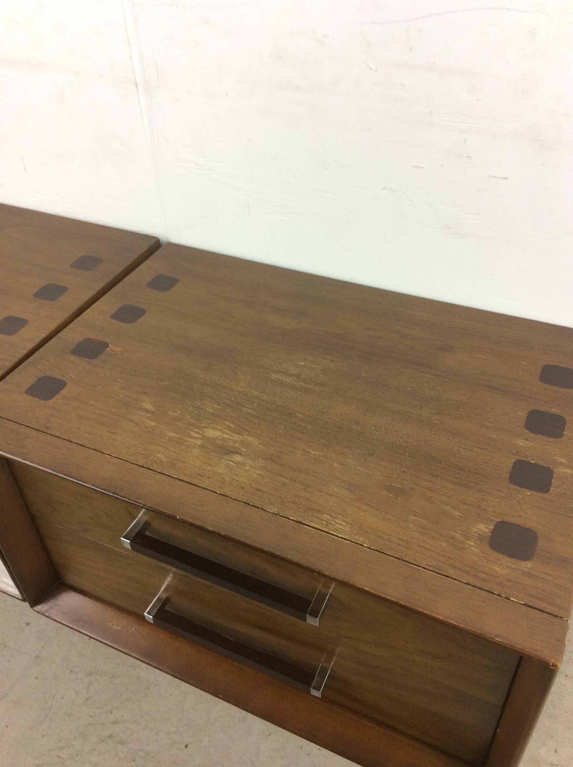 This pair of mid century modern nightstands from the Tower Suite by Lane Furniture feature hardwood construction, walnut veneer with original finish, rosewood drawer pulls with chrome accents, and black painted base.

Dimensions: 26w 18d 20.25h


