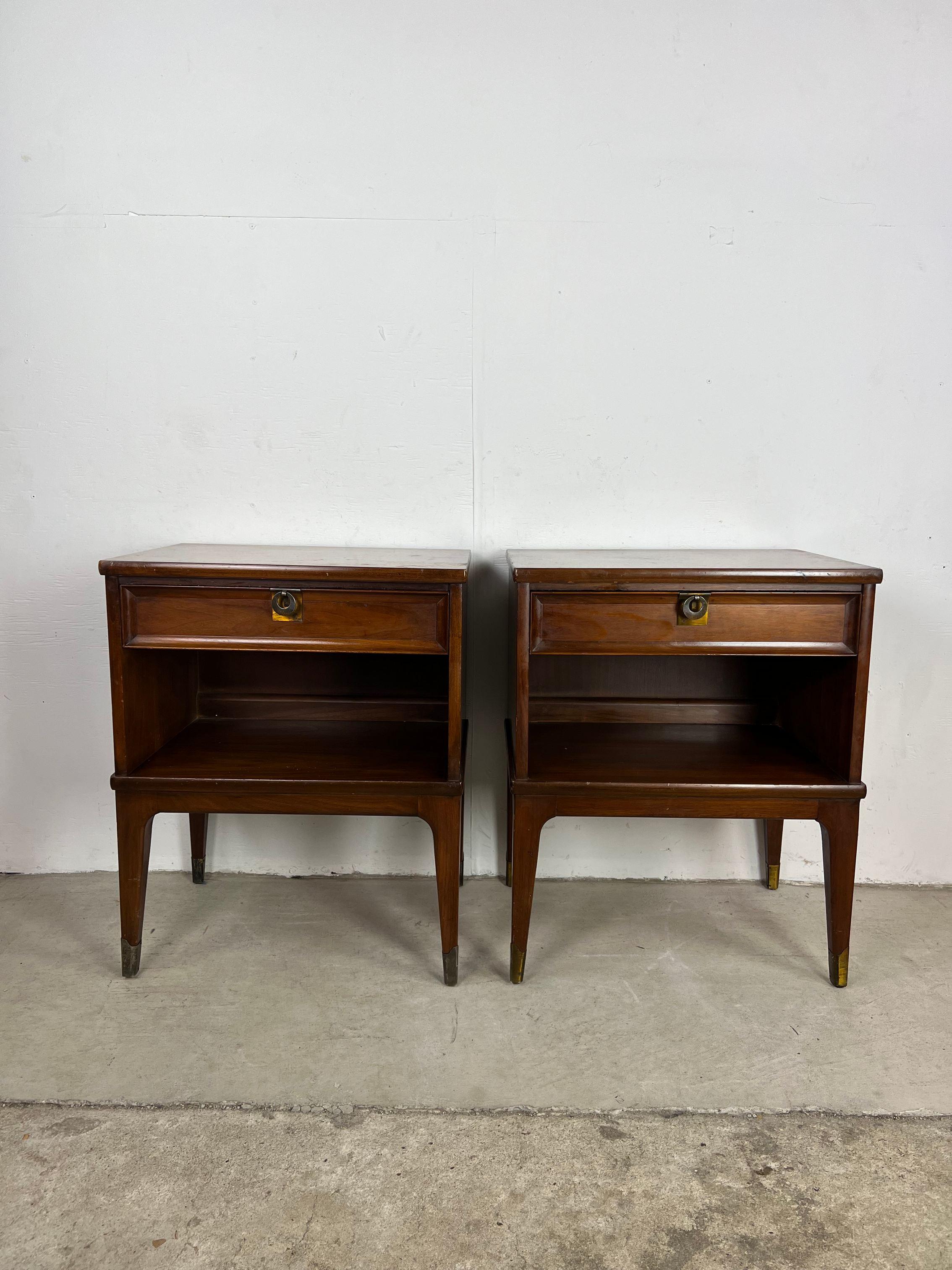 This pair of mid century modern nightstands feature hardwood construction, original walnut finish, single dovetail drawer with brass accented hardware, opened storage underneath and tall tapered legs.

Matching. lowboy dresser & gentleman's chest