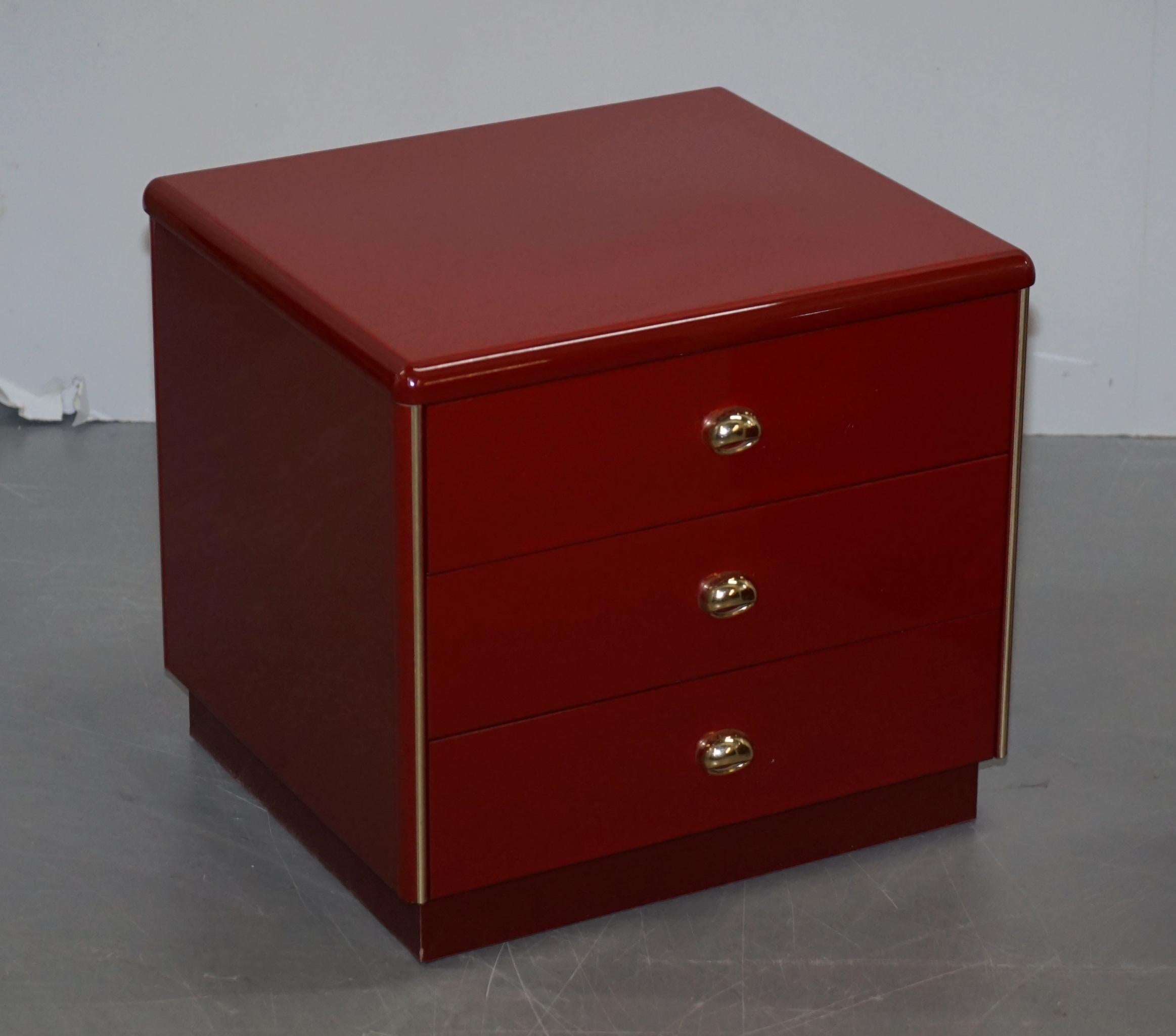 We are delighted to offer this seriously cool pair of Mid-Century Modern side table sized chest of drawers finished in red with gold hardware

These are very well made and good looking drawers, they look to be finished in some kind of Bakelite