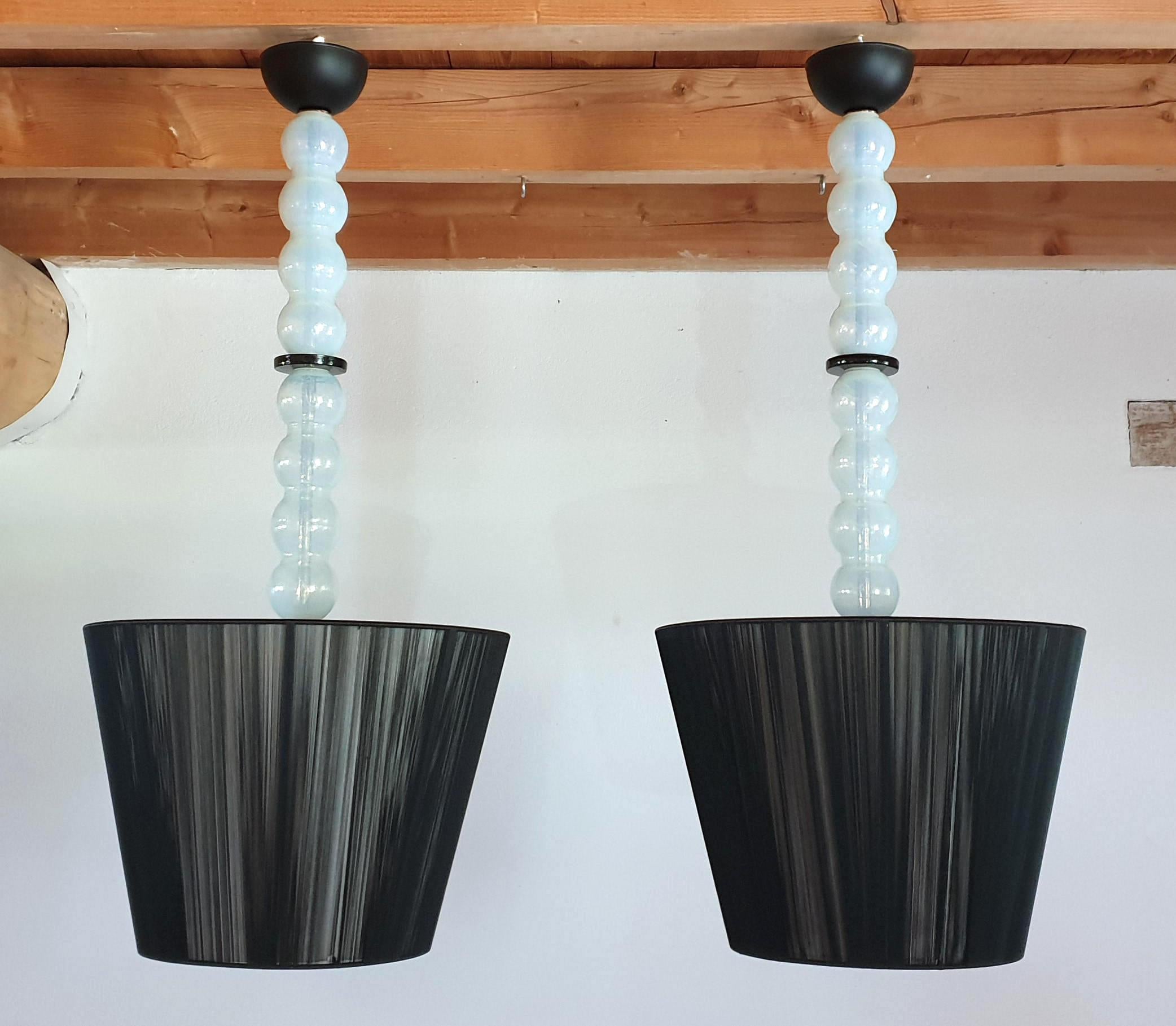 Pair of large Mid-Century Modern pendant light chandeliers, made of Murano opalescent glass, with black glass rings and new black fabric shades, with white interior. The opalescent glass has blue or green colors; but also amber hues when