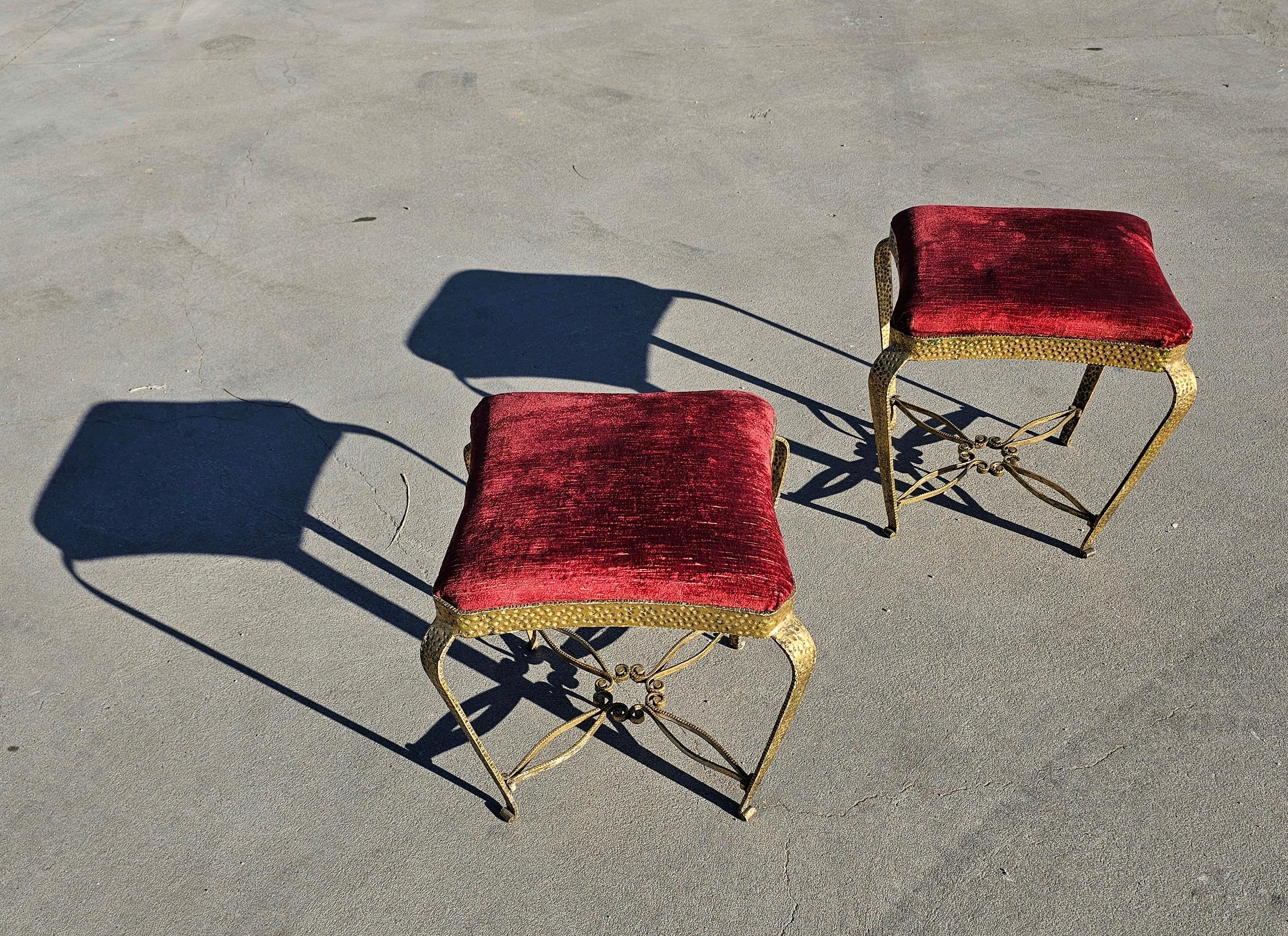 In this listing you will find a stunning pair of Italian Mid-Century Modern hand-hammered and gilt iron benches / stools / poufs / ottomans by Pier Luigi Colli. The pieces show a bold form united by a star form stretcher. All work is hand done and