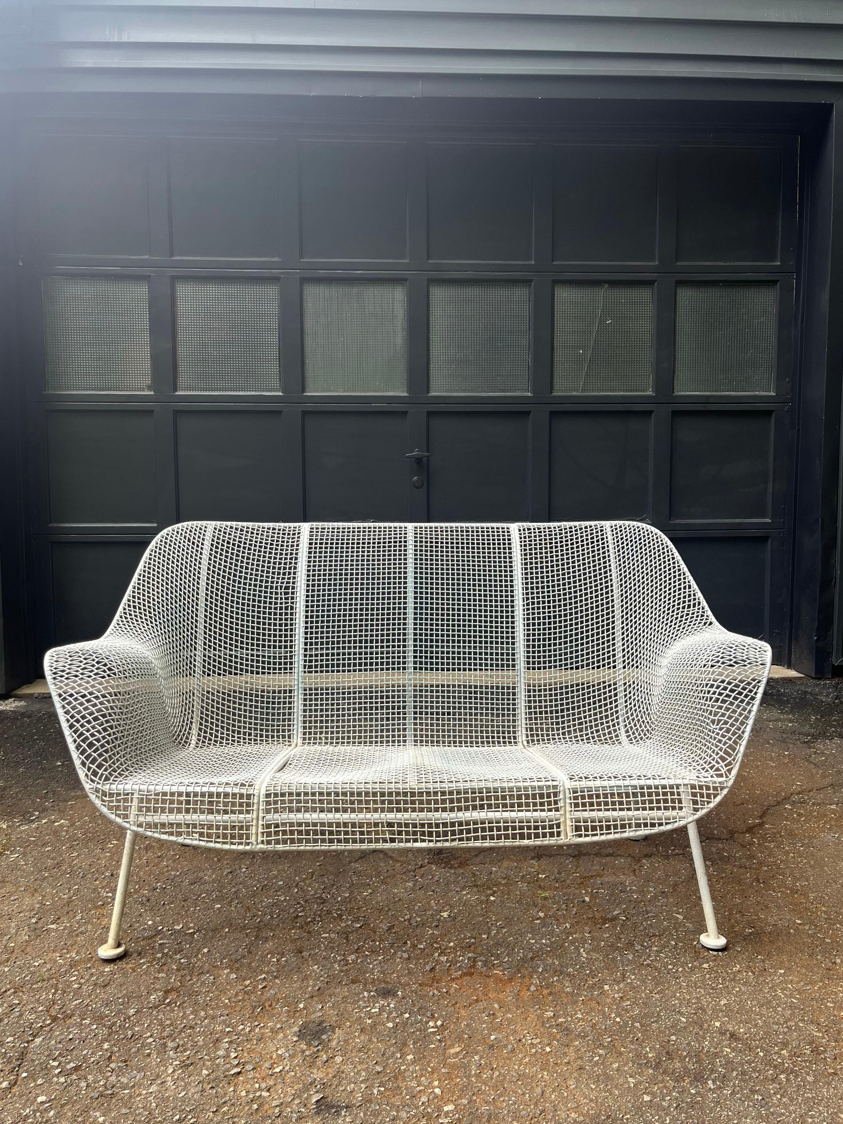 'Sculptura' wrought iron set of settees designed by Russell Woodard. Circa 1950s.

28”H x 54”W x 27”D x 13”H

The metal is in excellent vintage condition with minimal wear.

Price is per settee. Would sell separately.