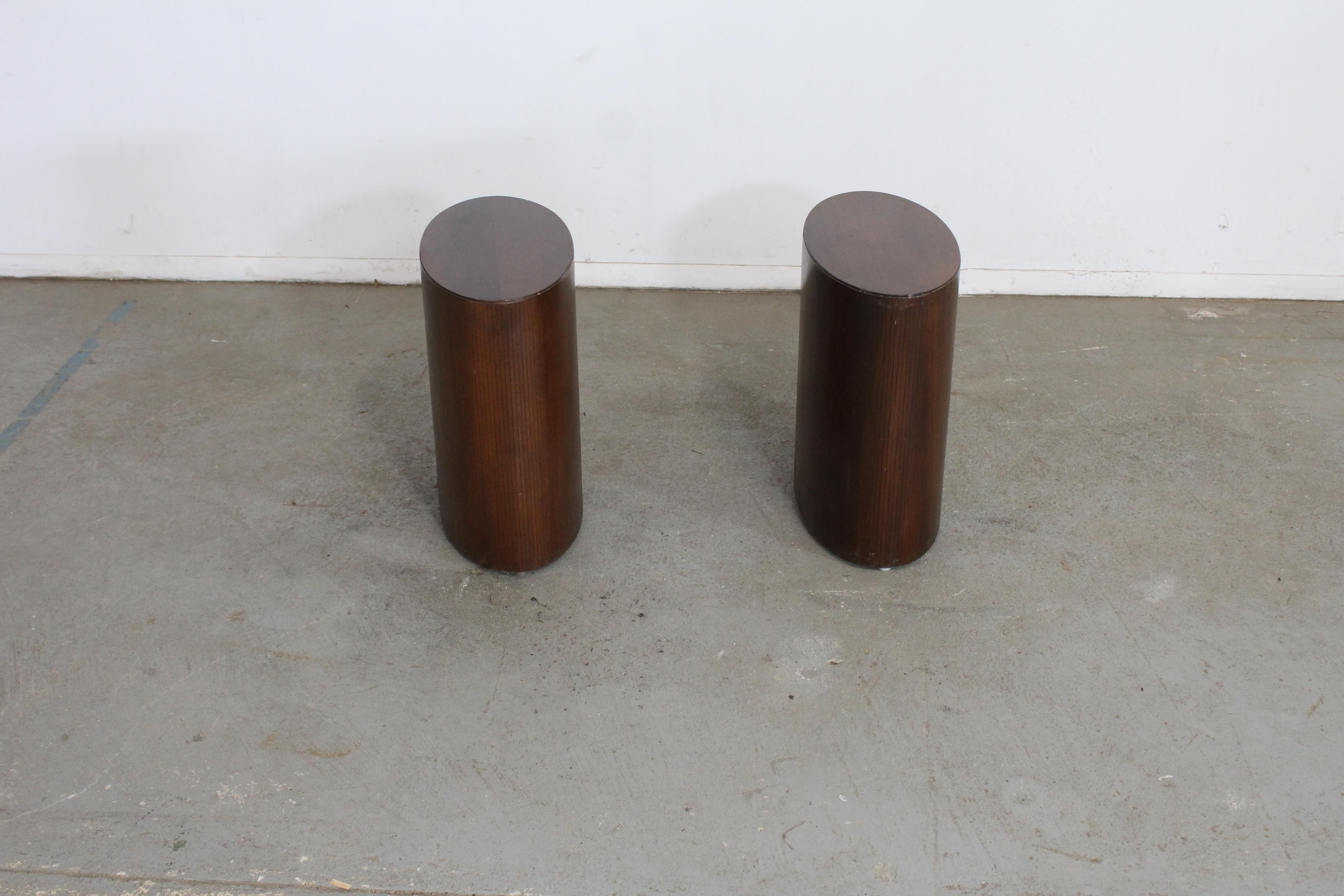 Pair of Mid-Century Modern Oval Walnut Pedestal/Stands/End Table by Lane

Offered is a beautiful pair of Mid-Century Modern Walnut pedestal/stands. The set is highly unique. The Oval shape helps offset the right angles of any décor. The wonderful