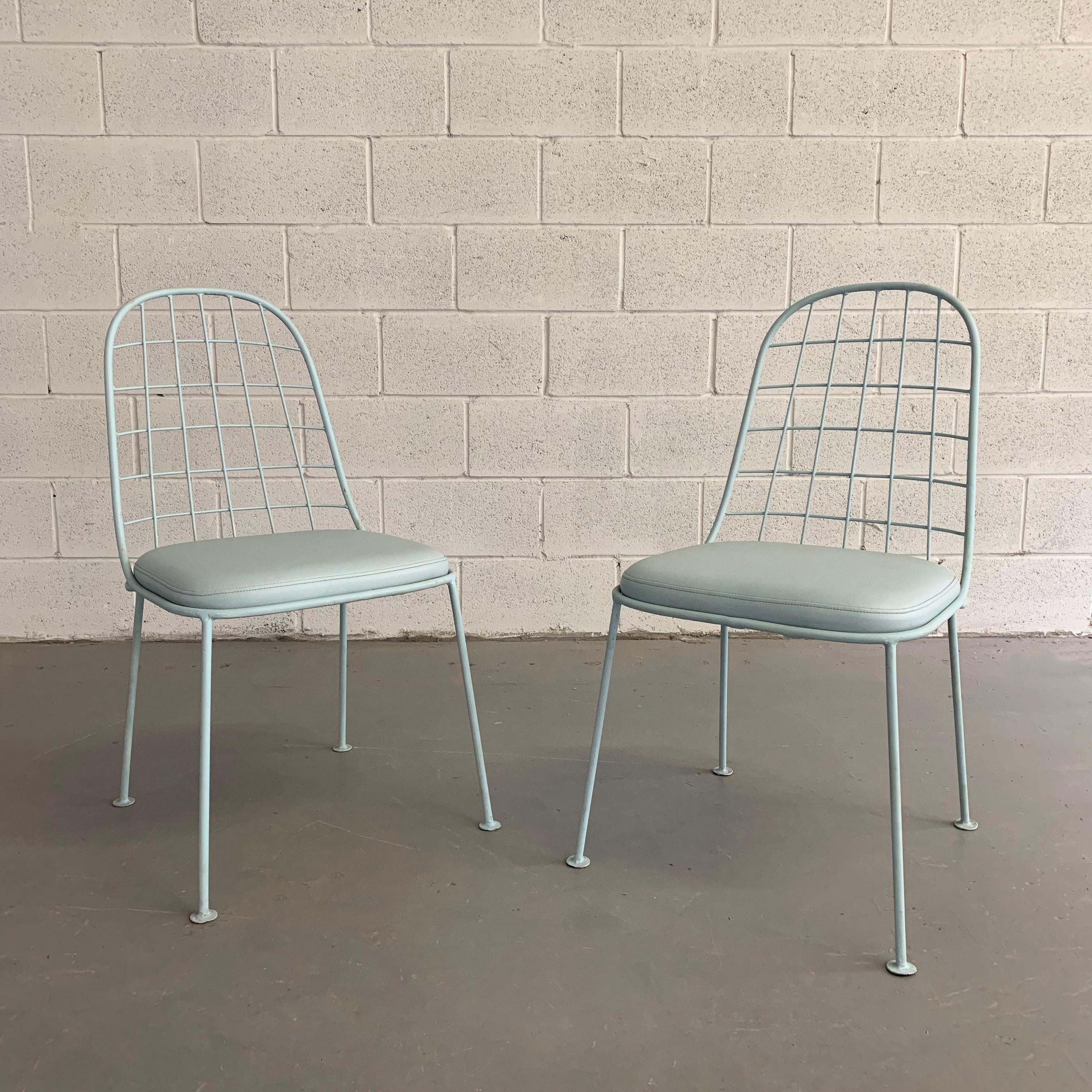 Pair of Mid-Century Modern, outdoor, patio, garden chairs feature painted, wrought iron grid frames with matching vinyl upholstered cushions.