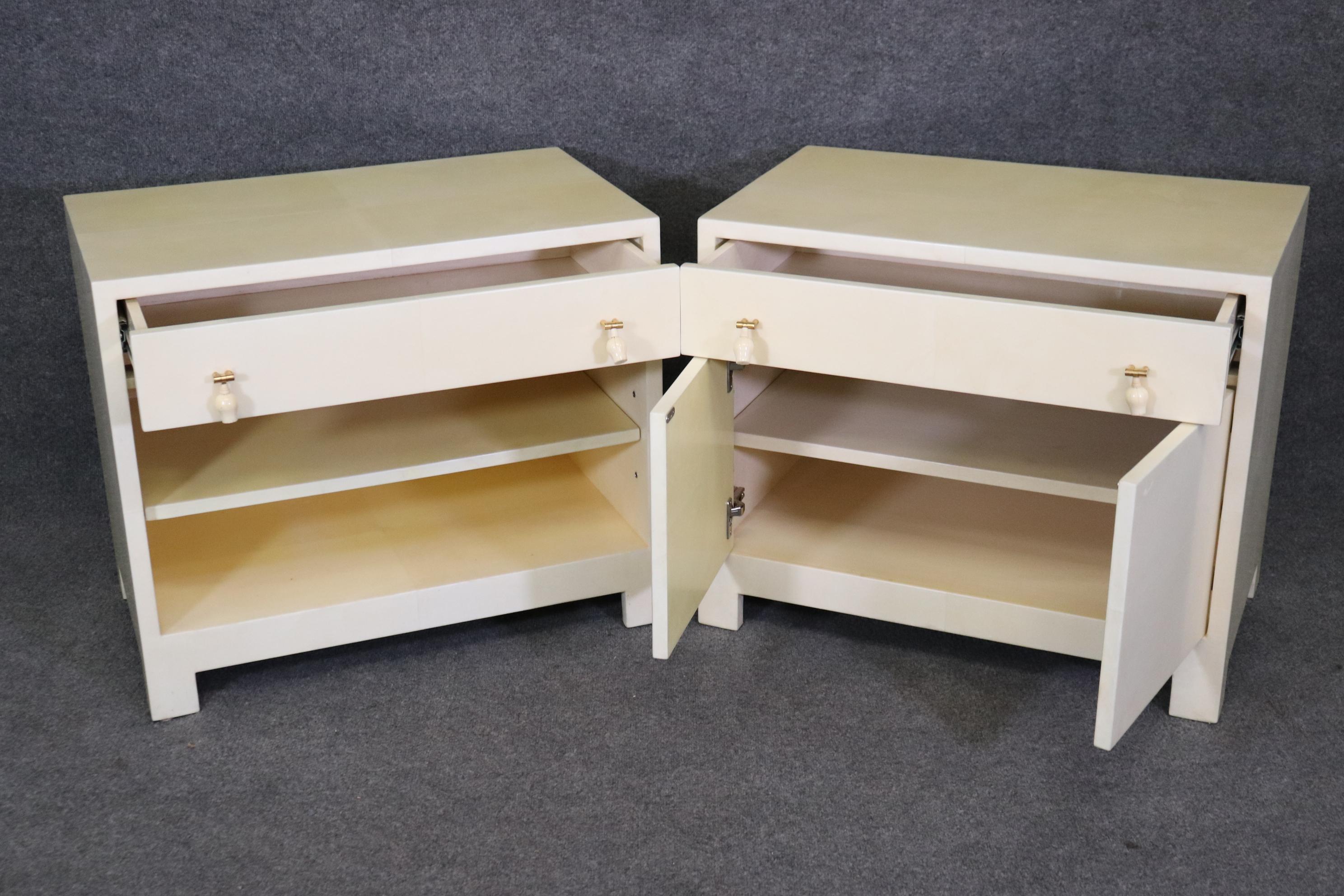 This is a nice pair of sophisticated parchment veneered nightstands in the style of Karl Springer. They each measure 30 inches wide x 25.25 tall x 19.5 deep and date to the 1970-80s era. They are in good used condition with minor signs of wear and