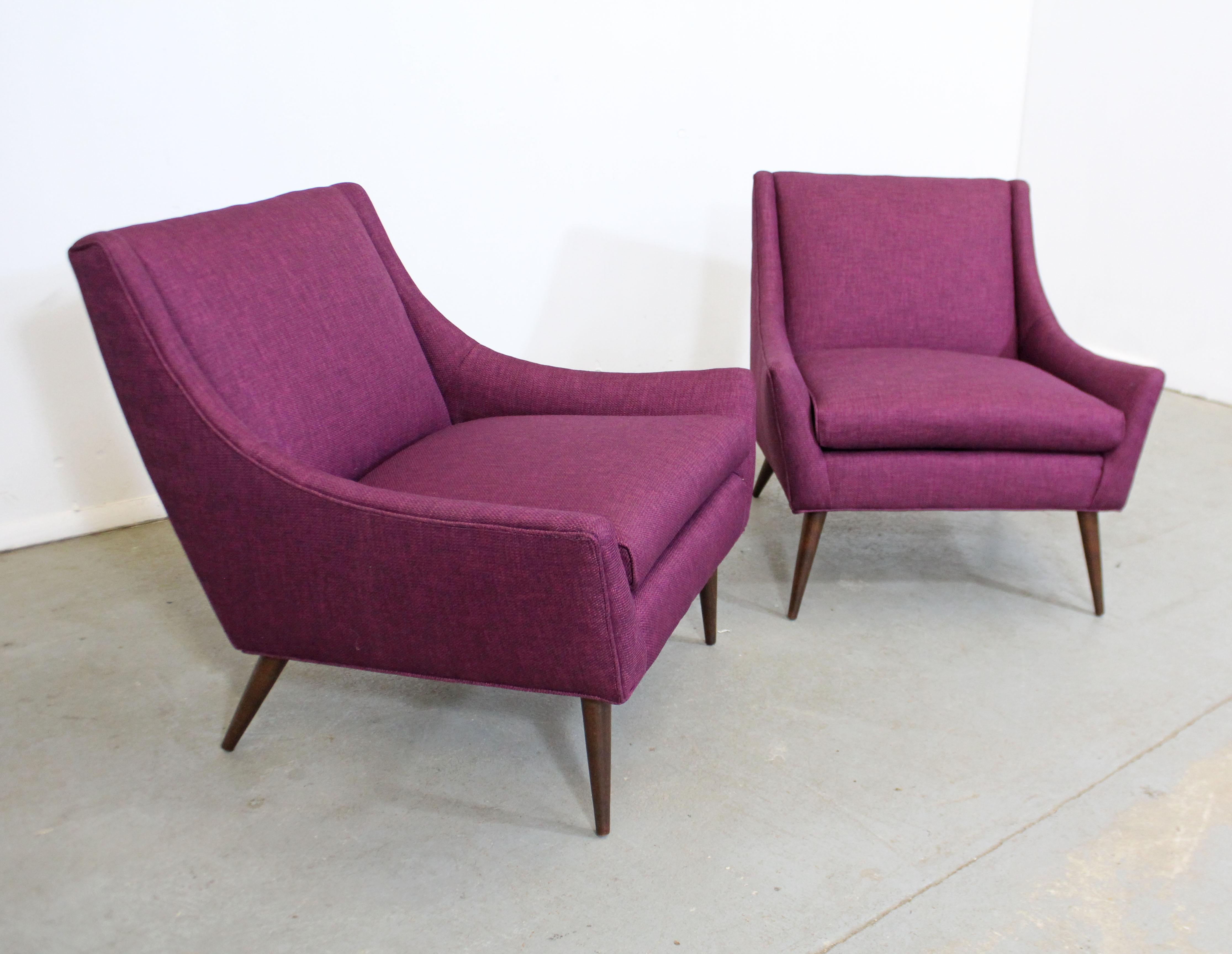 Offered is a pair of gorgeous Mid-Century Modern lounge chairs similar to the style of Paul McCobb. Absolutely incredible lines on these chairs. They have been freshly reupholstered with 'Wild Raspberry' textured fabric. Includes arm and back