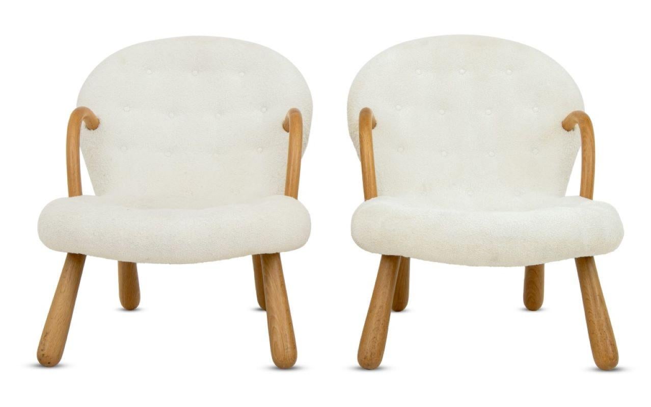 Pair of mid-century modern Philip Arctander style Clamshell chairs with white button tufted fabric, walnut arms and four legs, unmarked. 
Dimensions: 35.5