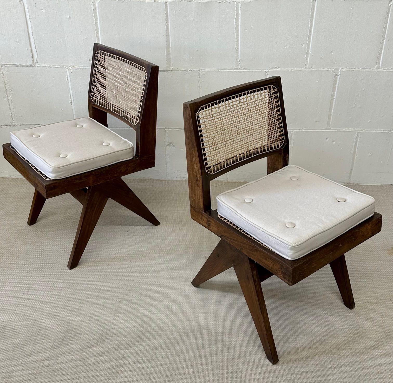 Armless dining chairs, Model PJ-SI-25-A, attributed to Pierre Jeanneret
 
Set of two armless dining chairs having a compass type double side leg assembly, connected by two crosspieces at the top. Each chair comes with a new two inch cream linen