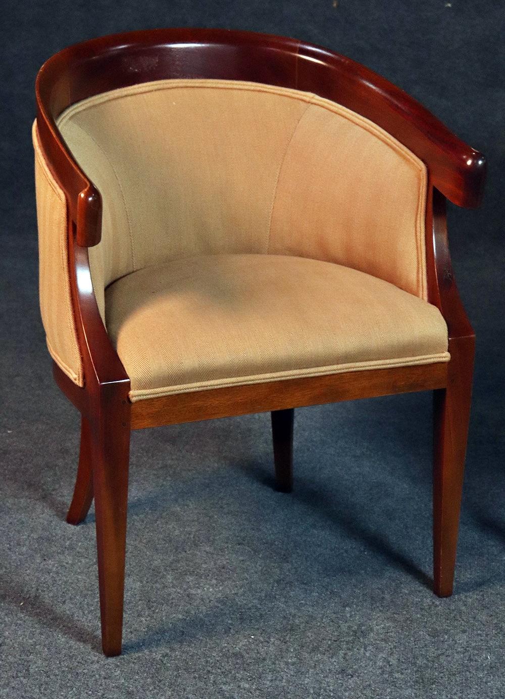 Pair of Mid-Century Modern Regency style walnut club chairs with bow tie dovetailed backs and herringbone upholstery.