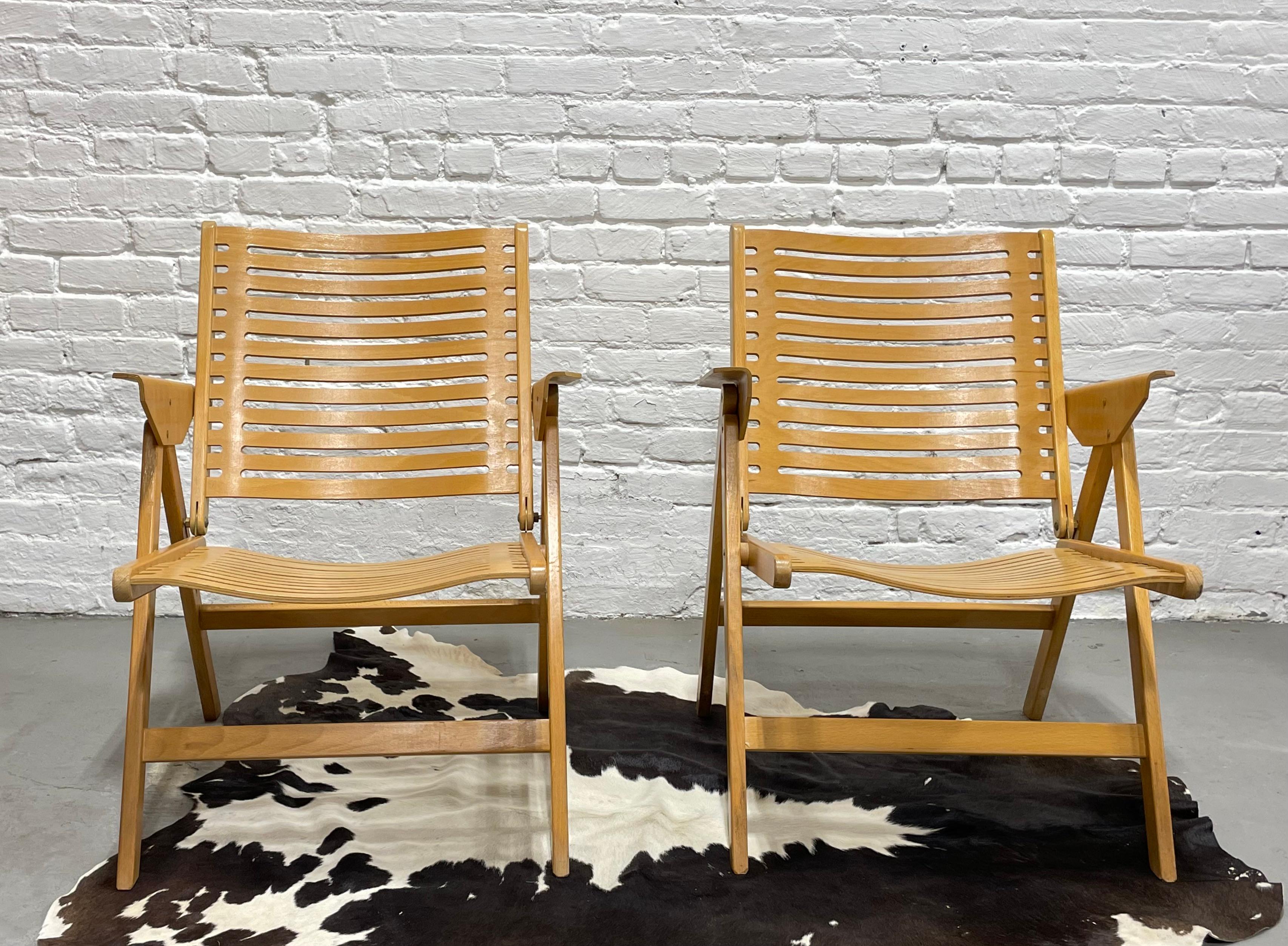 Iconic Pair of vintage folding Rex Kralj armchairs chairs designed by Slovenian architect, Niko Kralj. Made of solid beech and bent beech plywood. This lovely pair offers comfortable and stylish seating in your living room yet the chairs can easily