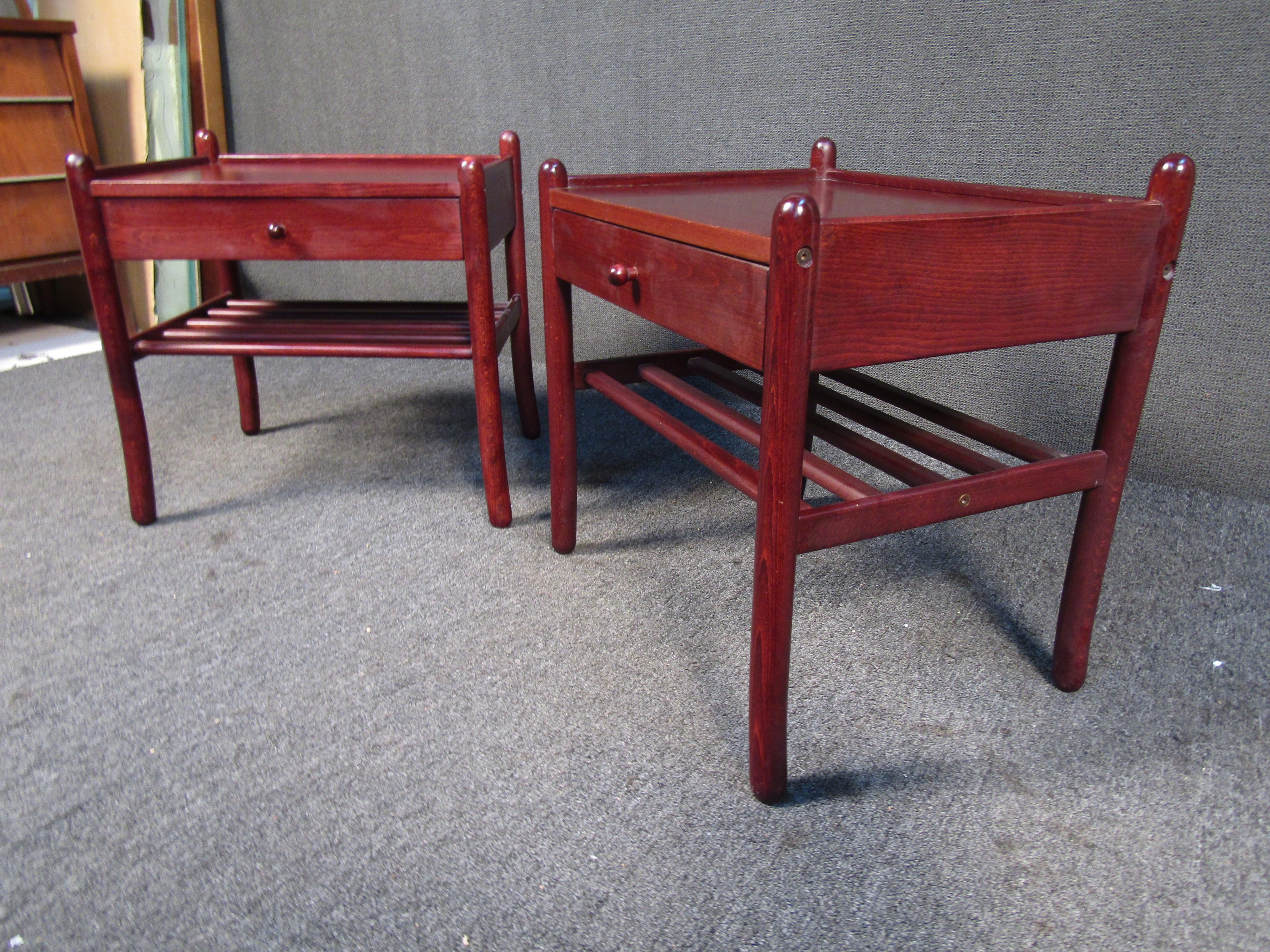 This beautiful pair of vintage end tables shows off a rich shade of rosewood applied to an elegant design that includes a drawer, lower shelf, and sculpted legs. Please confirm item location with seller (NY/NJ).