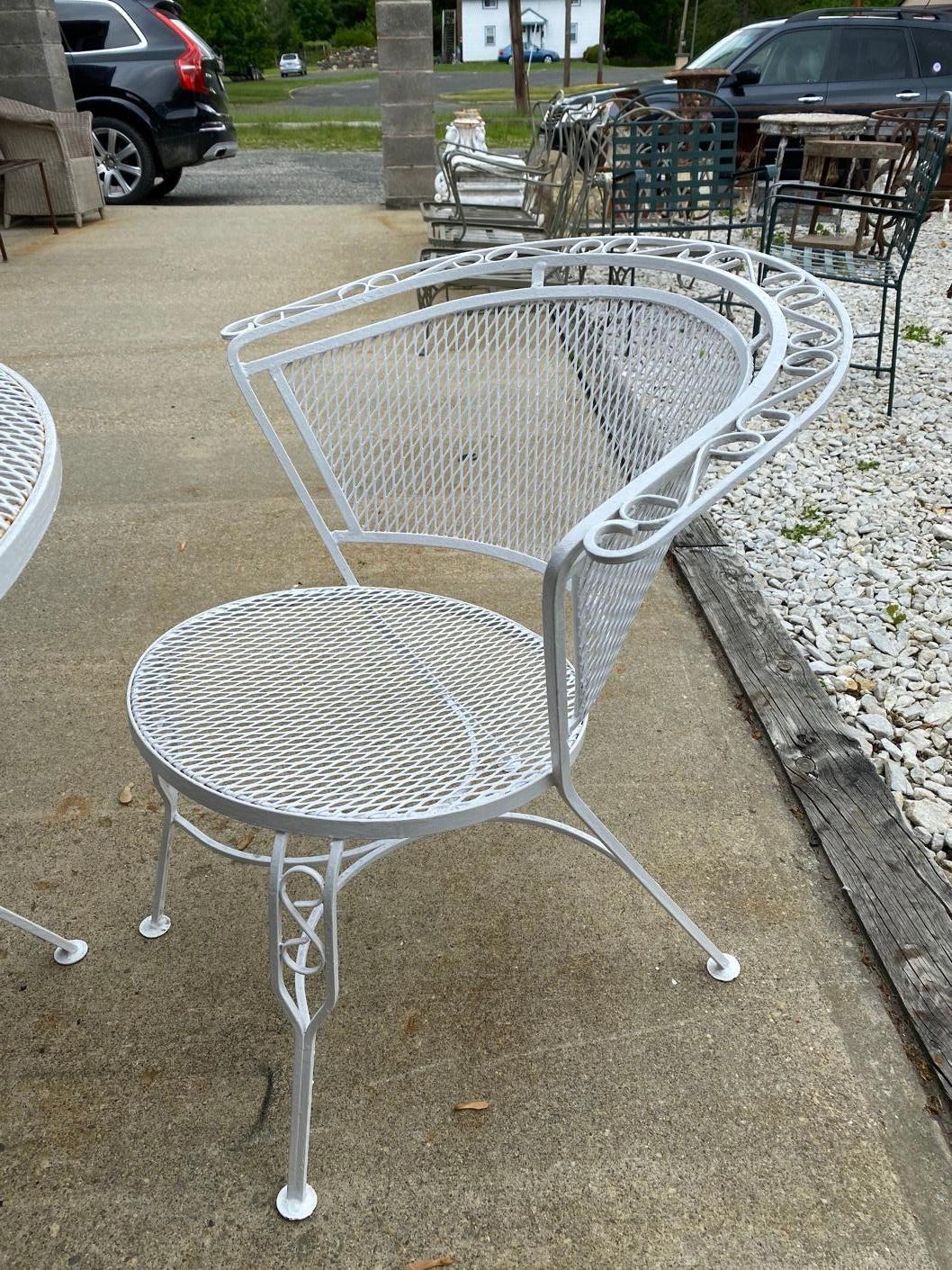 Pair of outdoor garden dining armchairs with Classic diamond mesh wire seat and back. The armchairs are very comfortable with a curved barrel back. The set is painted white ready to be used in any patio, porch or garden. Vintage Woodard style for