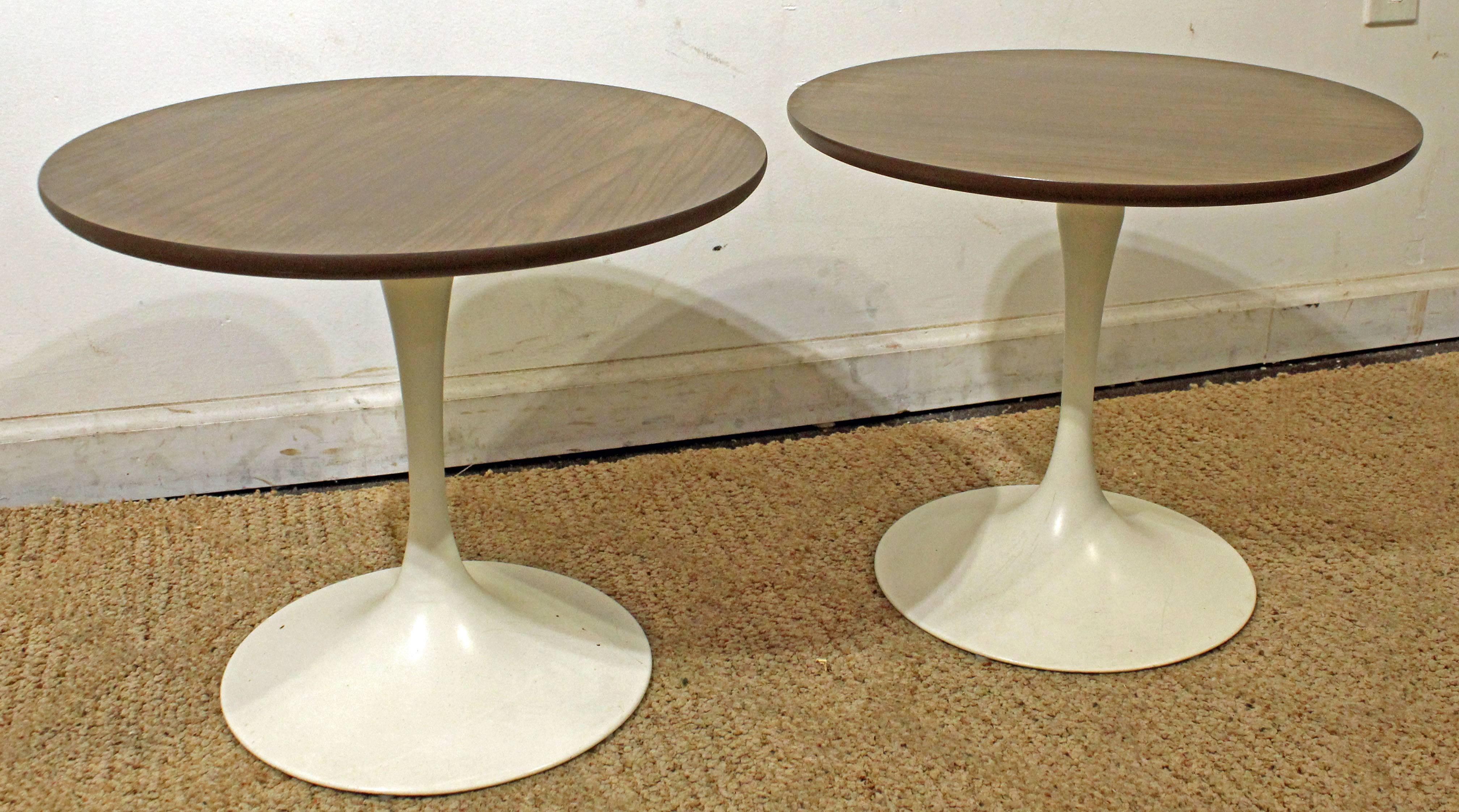 This set includes two side tables with laminate tops and metal bases, similar to the style of Eero Saarinen. They are not signed.