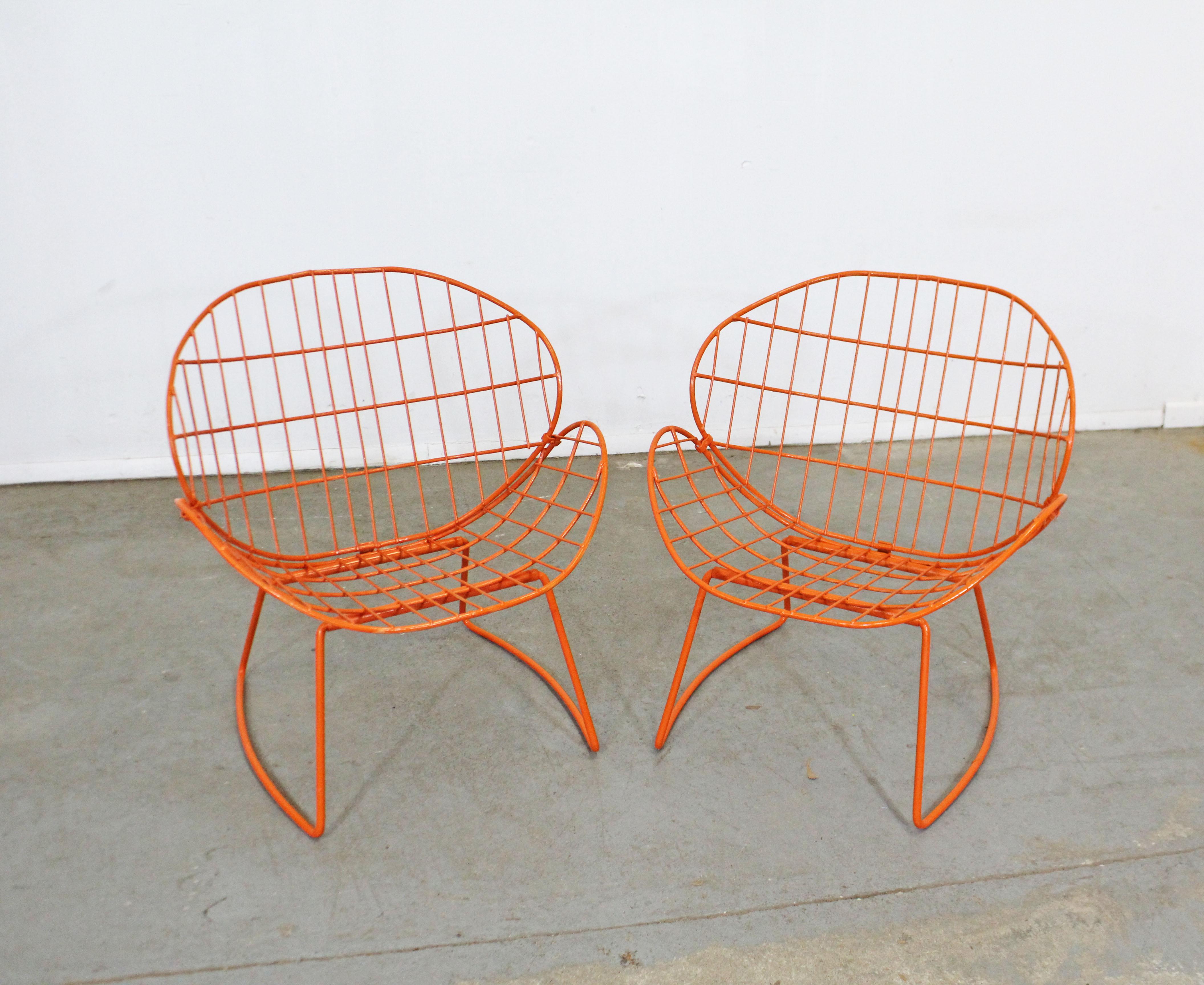 What a find. Offered is a pair of awesome vintage iron 'clam shell' outdoor/patio chairs. These chairs are extremely unique, featuring clam-shaped wire backs and seats with curved legs. They're in excellent condition, structurally sound, and have