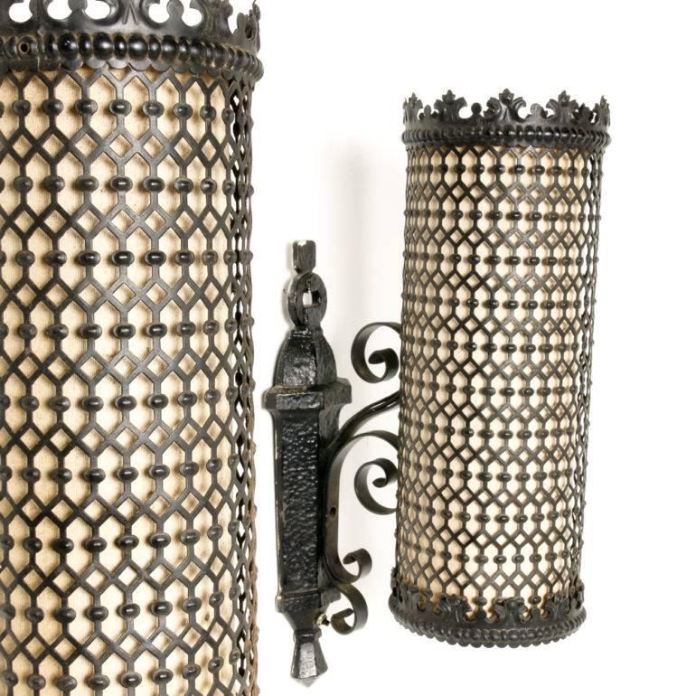 An unusual pair of Mid-Century Modern metal wall sconces with pierced metal, Moorish-influenced, cylindrical shades.

Originally from the Terminal City Club in Downtown Vancouver, circa 1960.




