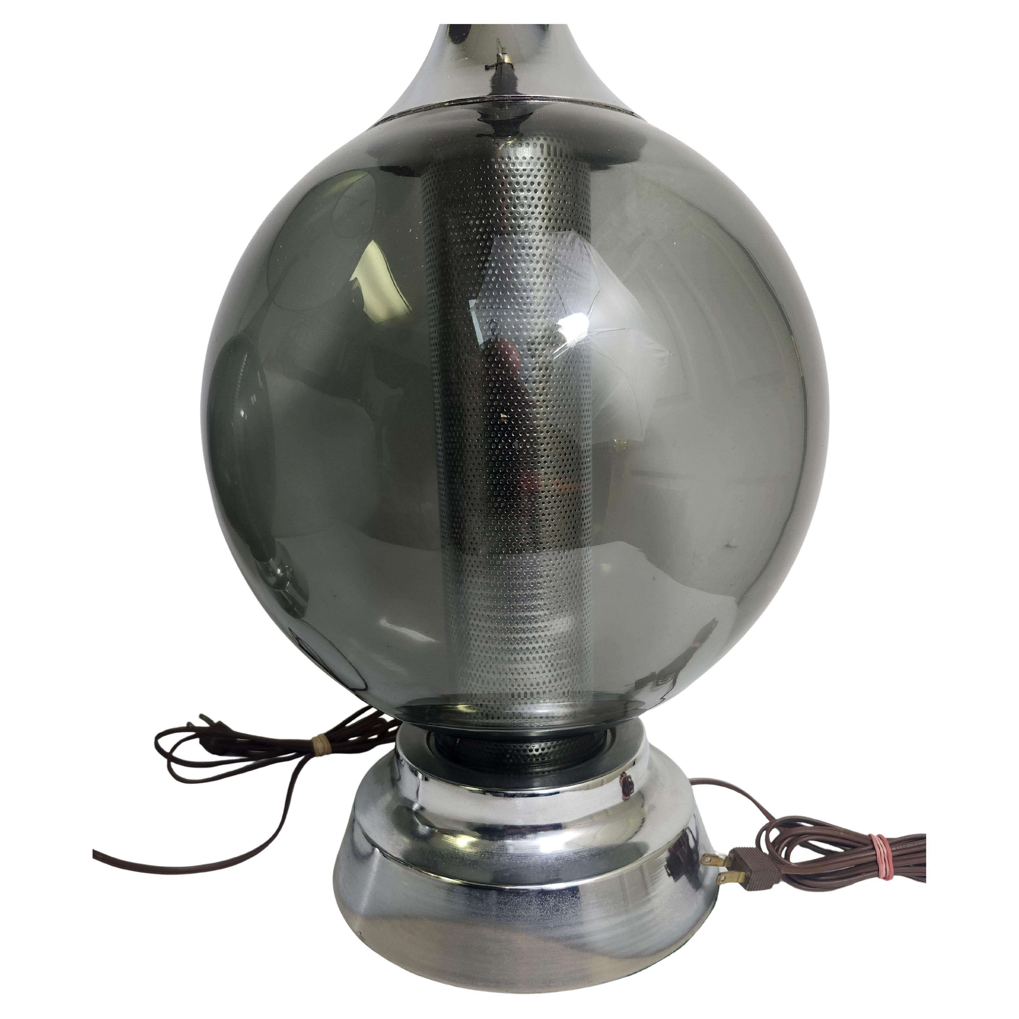 Fantastic pair of C1970s table lamps with large blown glass ball which encompasses a diffuser type element in the center thats tapered and reflects the light from above. Black shades are included but are a littke faded. Lamps themselves are in