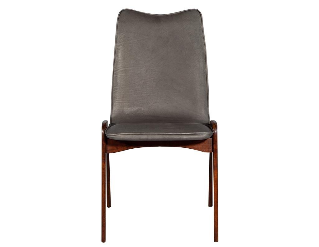 Pair of Mid-Century Modern side chairs. Sleek Scandinavian styled Mid-Century Modern side chairs recently reupholstered in a Fumo brown Italian leather.
