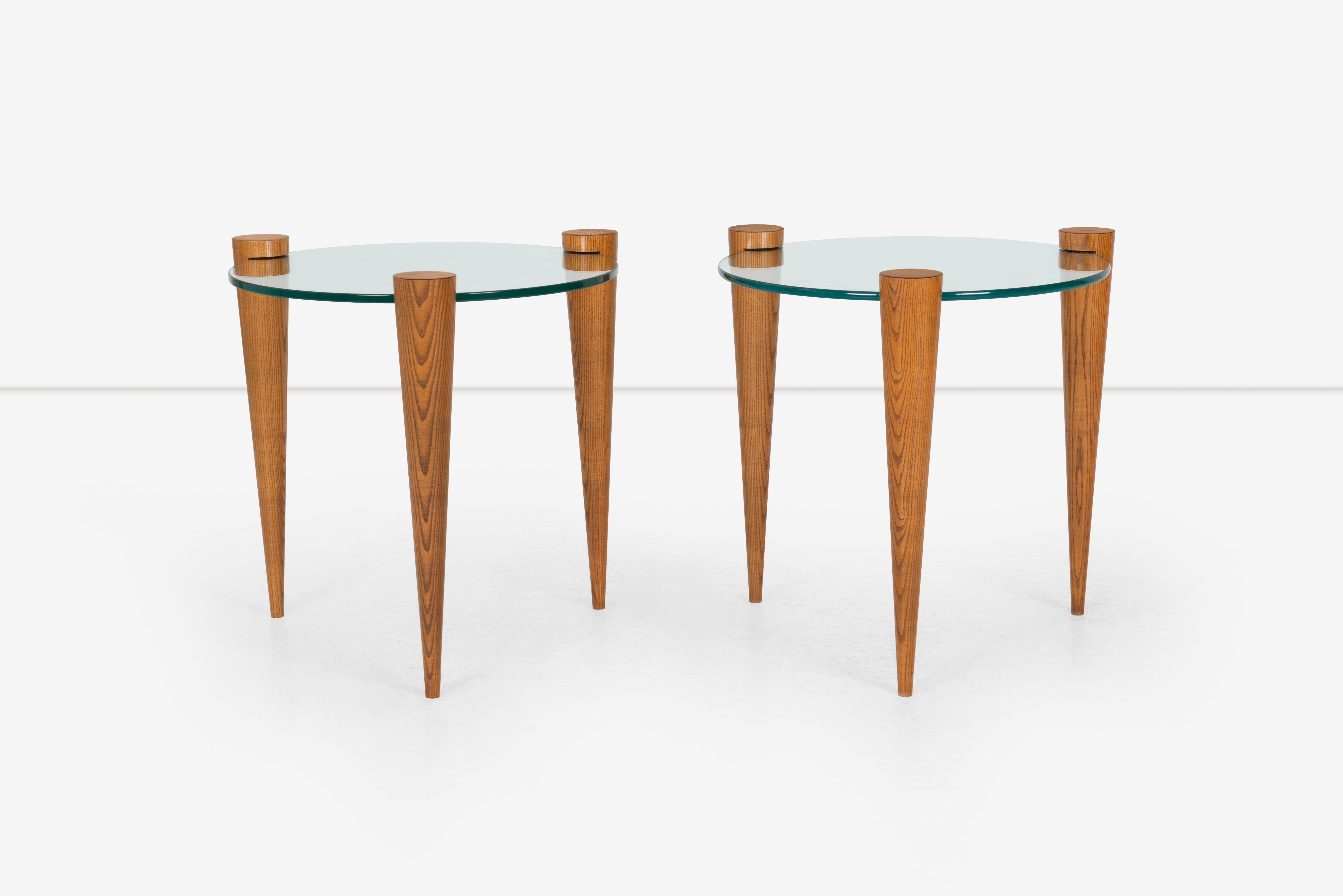 Pair of side tables with circular glass and oak cone legs.