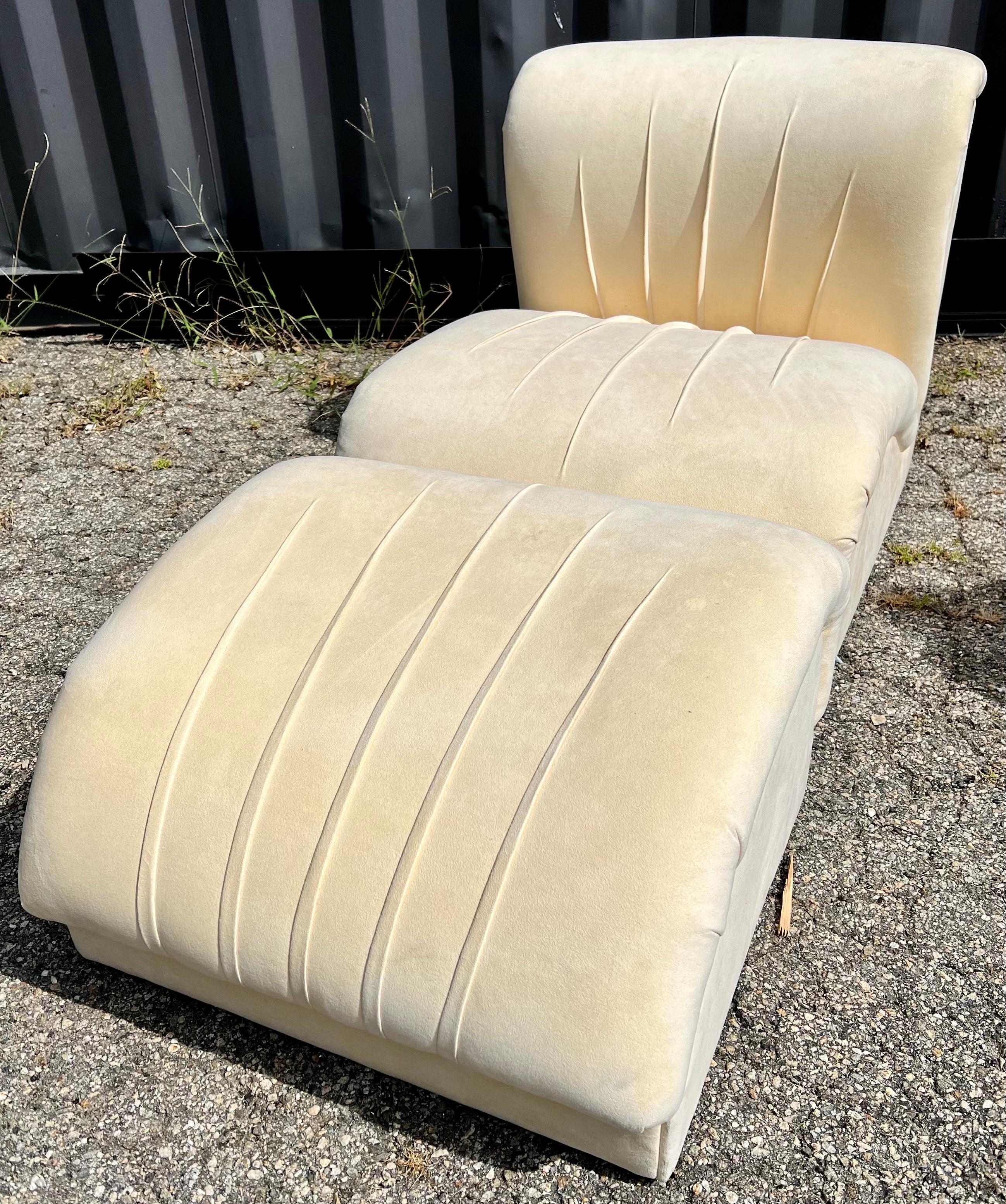 Mid-Century Modern custom pair of slipper chairs with one matching ottaman, three pieces in all. The upholstery appears to be original and is a cream colored suede. There is some age appropriate wear to the pieces and they could benefit from a