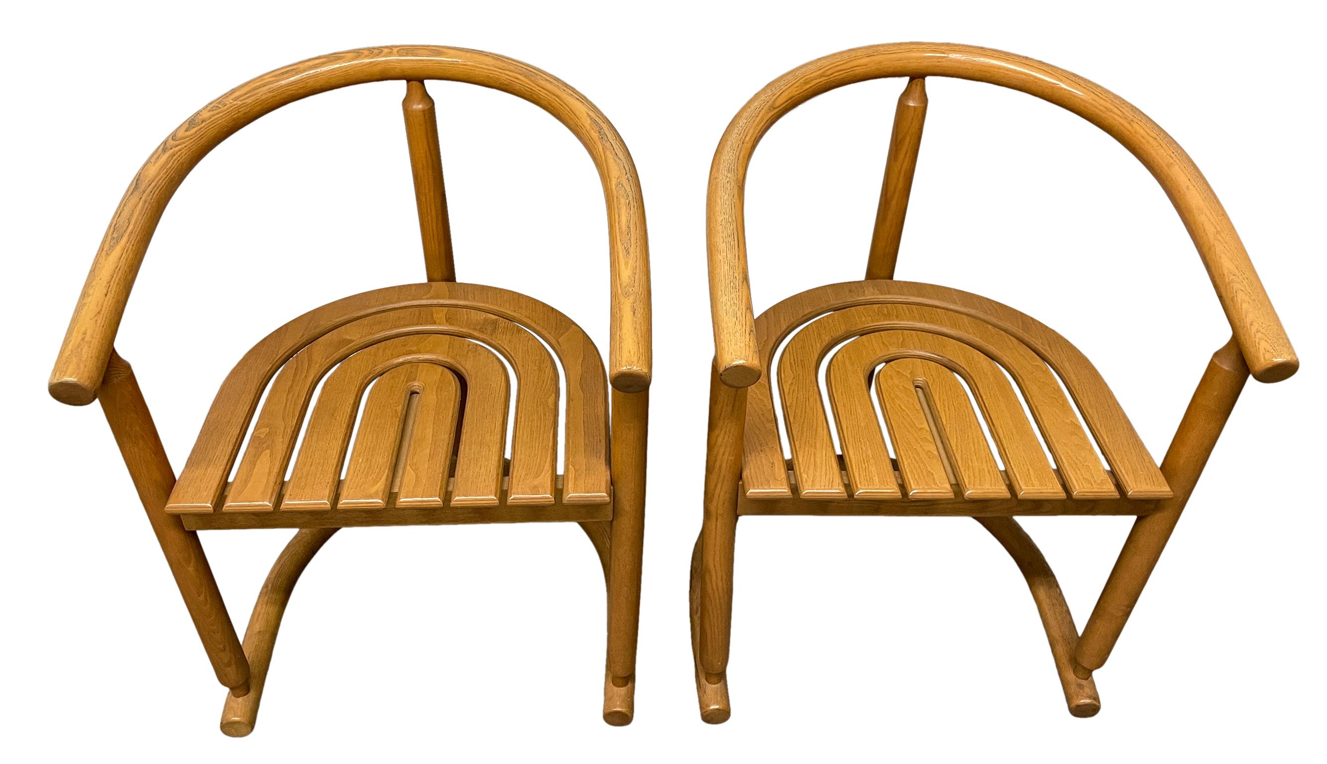 Pair of Mid-Century Modern solid oak horseshoe arm chairs by German company Allmilmö - Style of Nanna Ditzel. Beautiful designed pair of chairs. Amazing woodwork all Solid Oak curved wood and arched seat. Flat head screws used to assemble. No labels