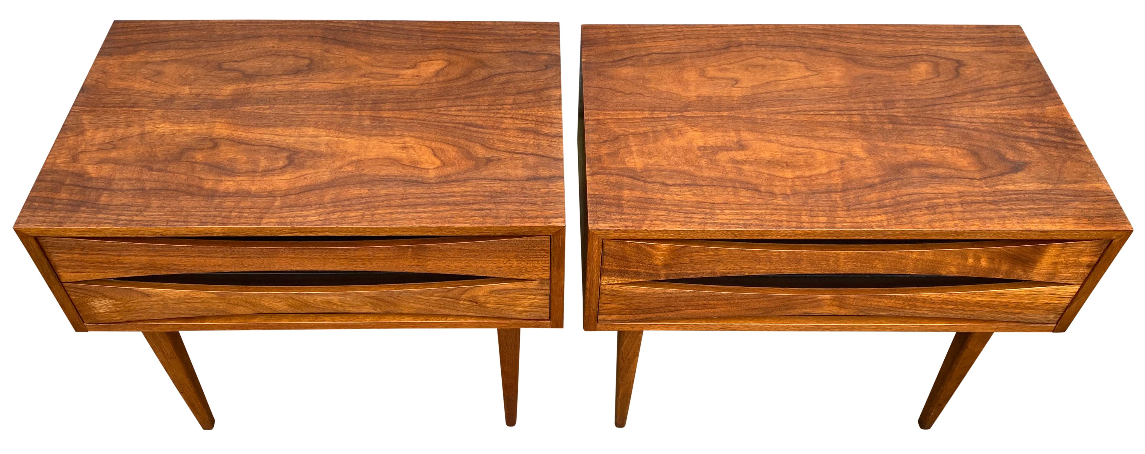Beautiful pair of Mid-Century Modern solid walnut nightstands style of Arne Vodder. Beautiful design American made circa 1960. Solid walnut and black lacquer details. Very clean drawer interiors. Made by West Michigan Furniture Company USA.