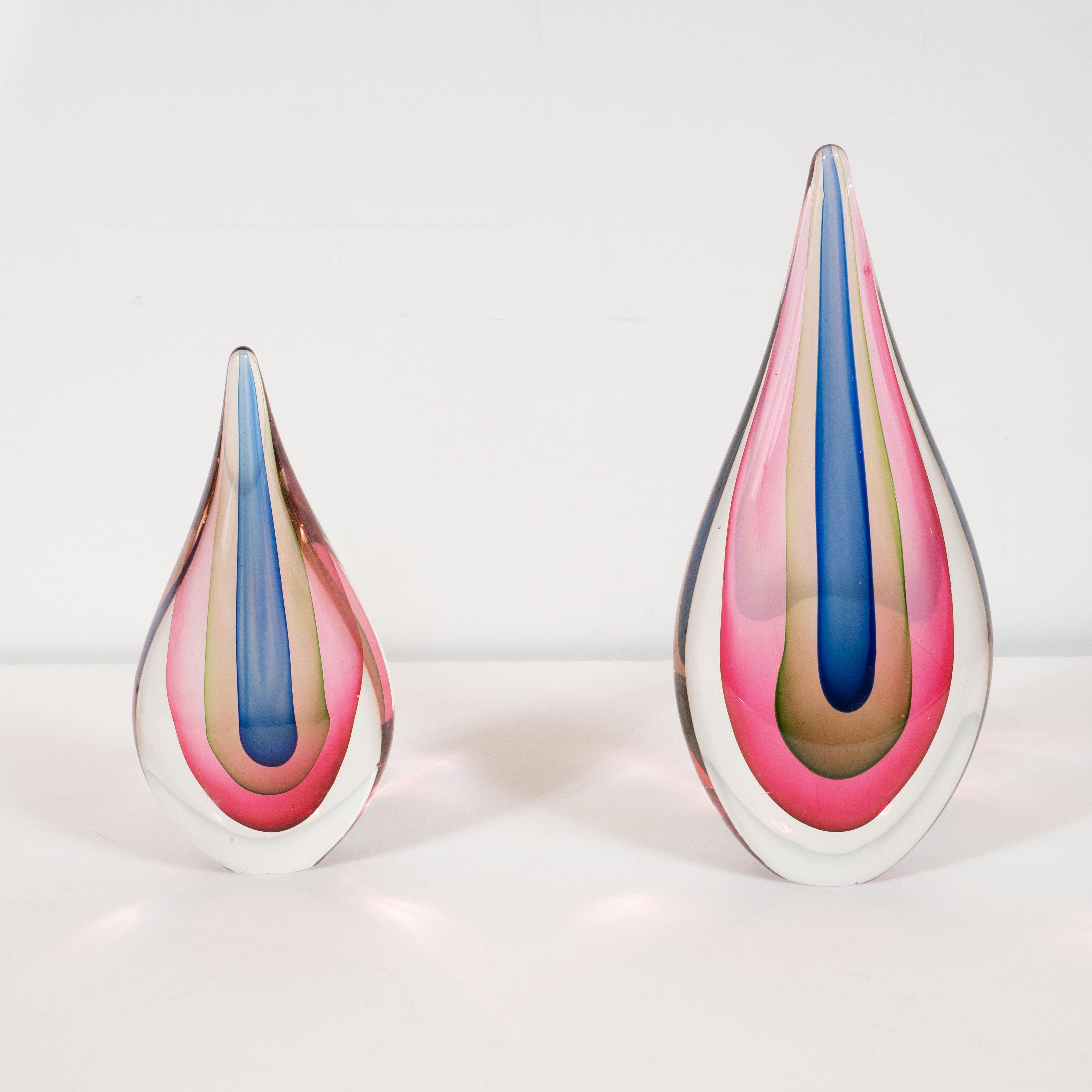 This stunning pair of objet d'art was hand blown in Murano, Italy- the island off the coast of Venice renowned for centuries for its superlative glass production, circa 1960. Composed of tear drop forms, these Sommerso glass objet d'art feature