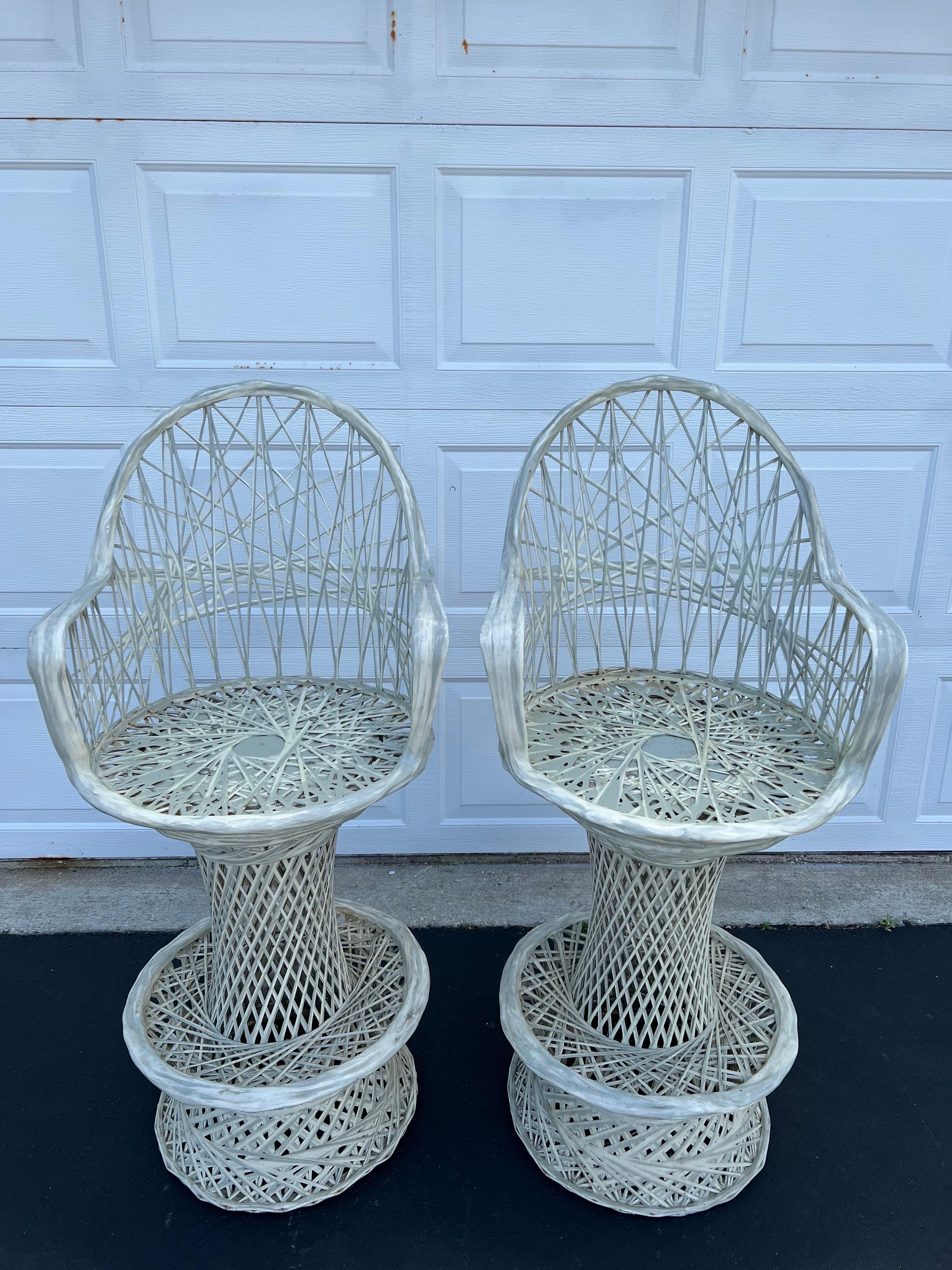 Pair of Russell Woodard Spun fiberglass bar stools that swivel. Perfect for that poolside bar in Miami. Heavy and well constructed. These chairs are an off white . The lighting makes them look blue. These can also be sprayed a gloss white.