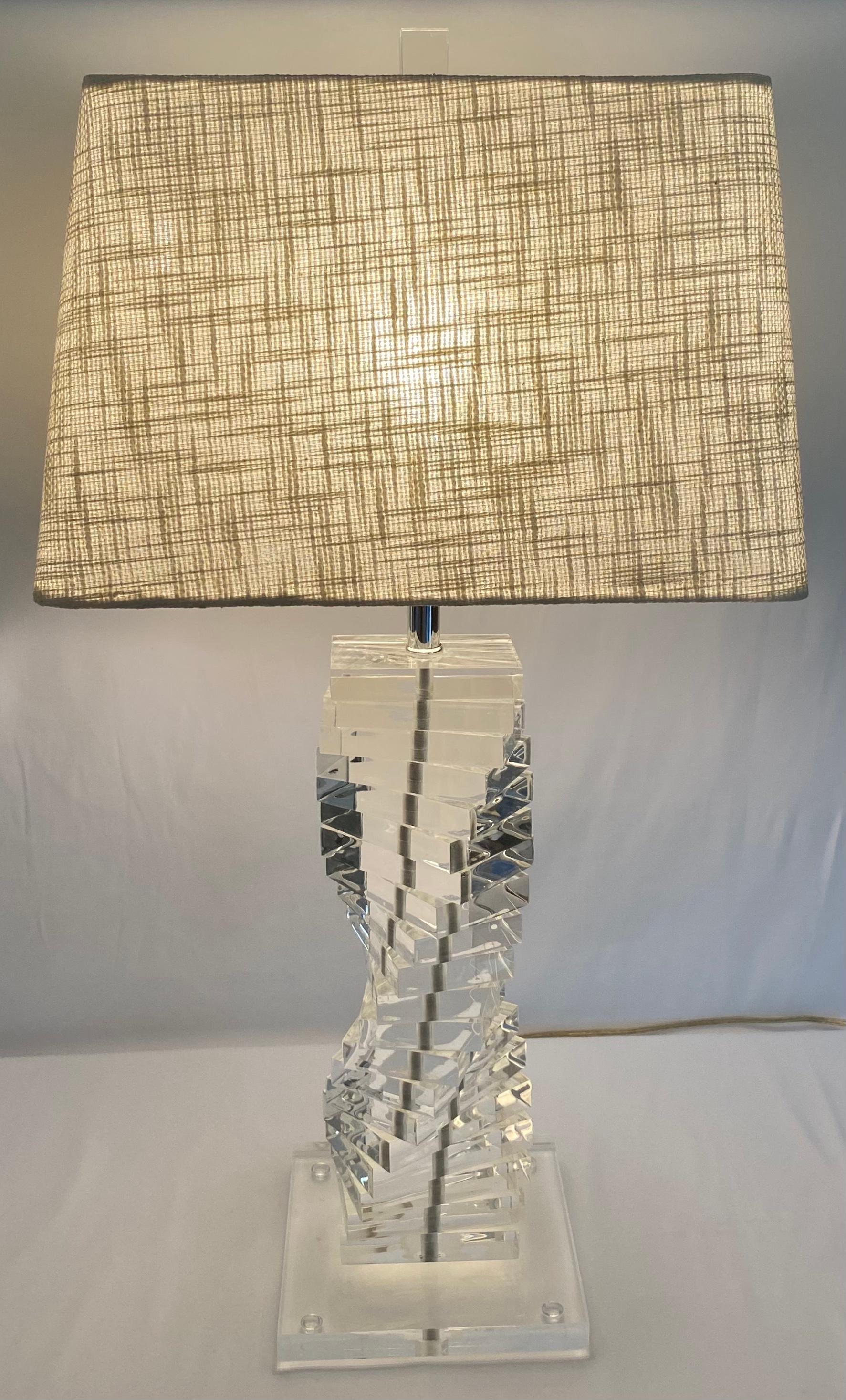 Superb pair of Lucite table lamps with a spiral stacked staircase design of clear Lucite by Karl Springer. 
Stylish and versatile. 

Measures: Depth 9 in. x Width 15 in. x Height 29.75 in.
These lucite table lamps would enhance any contemporary or