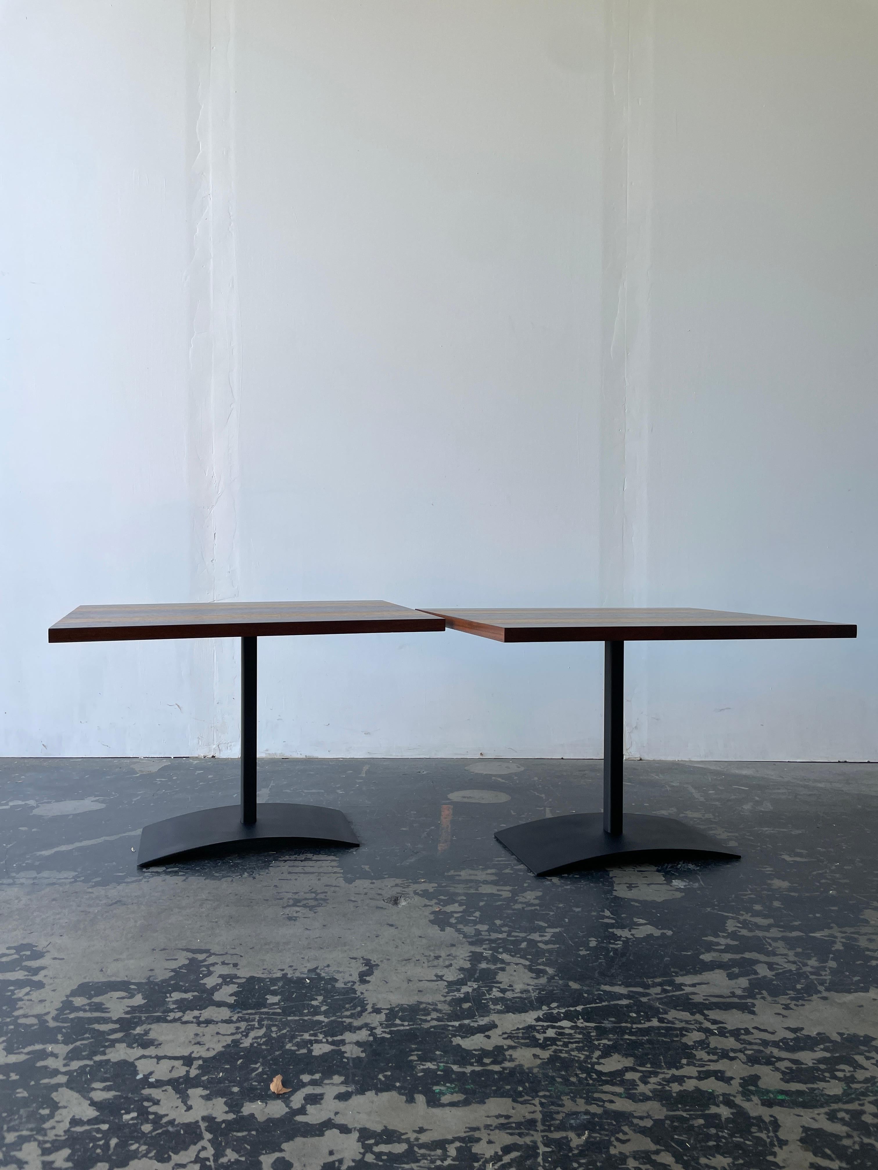 Restored beautiful striped wood end tables by Milo Baughman for Directioal. These are absolutely stunning in person. These tables are made of alternating rosewood, oak, and walnut. The tabletops sit upon a black lacquer steel base that is curved at