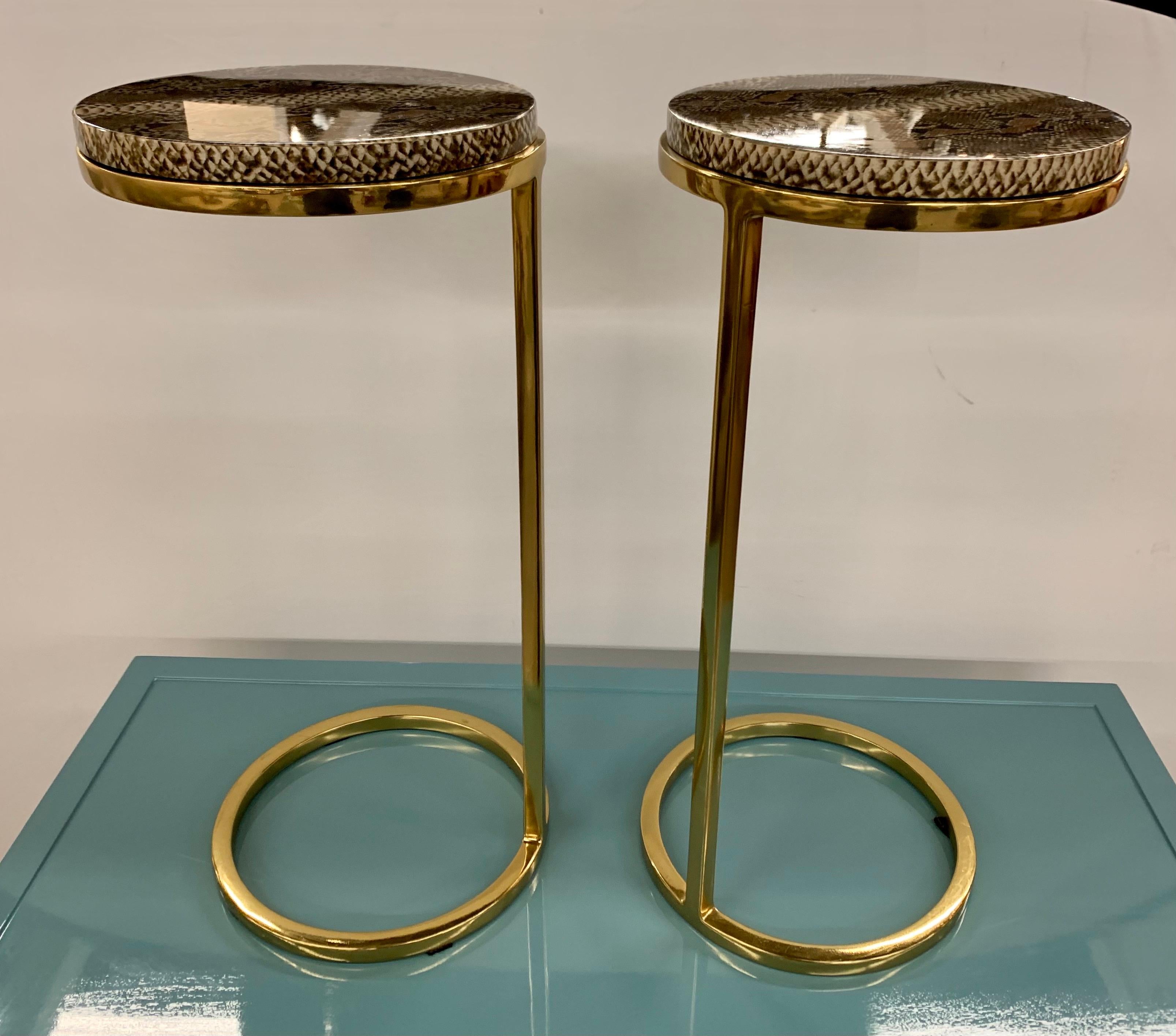 Elegant pair of brass and snakeskin design on resin cigarette table with circular top. Great lines and better scale. Now, more than ever, home is where the heart is.